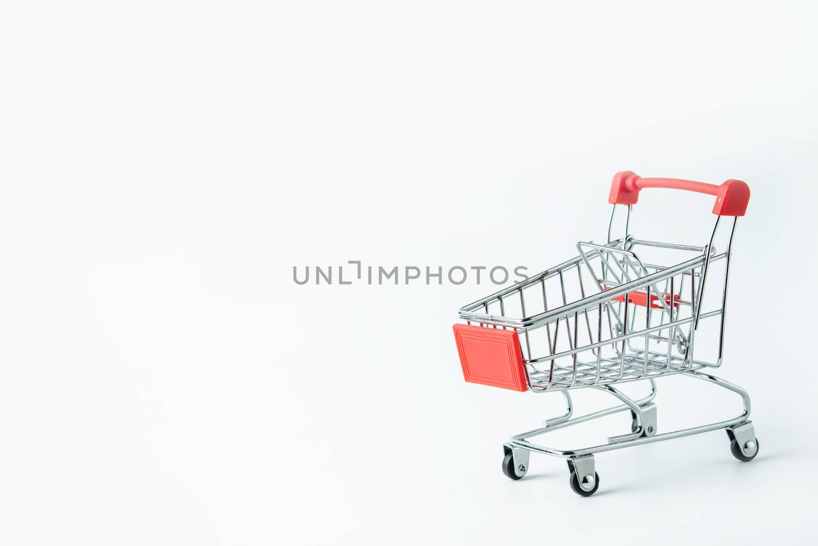 Shopping concept : Red shopping cart on white background with copy space