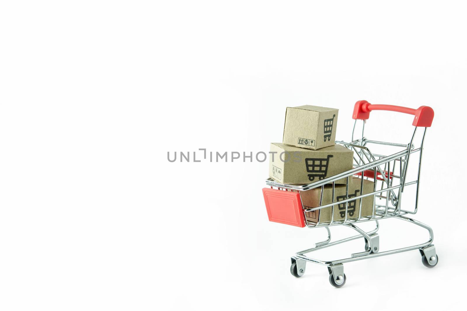 Shopping concept : Cartons or Paper boxes in red shopping cart on white background. online shopping consumers can shop from home and delivery service. with copy space