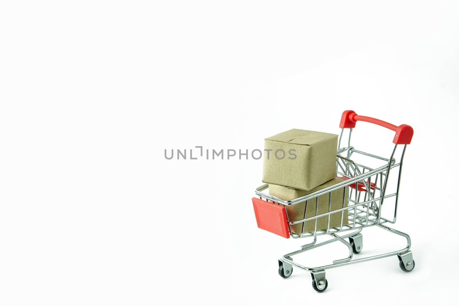 Shopping concept : Cartons or Paper boxes in red shopping cart on white background. online shopping consumers can shop from home and delivery service. with copy space