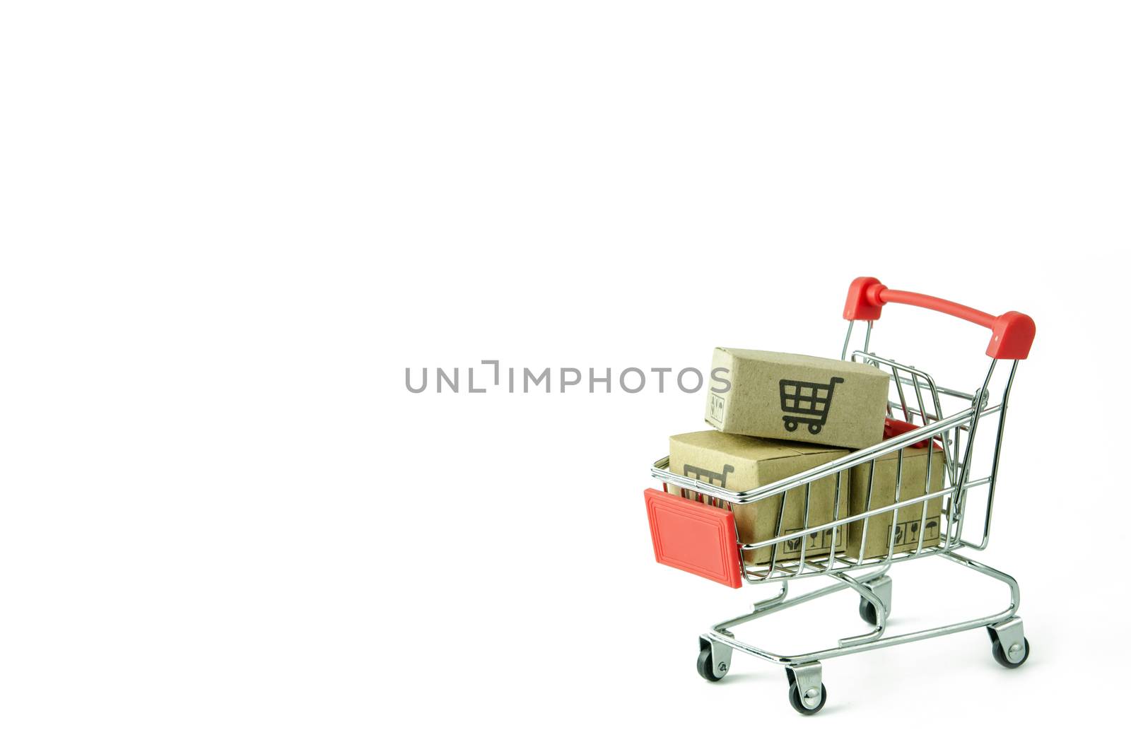 Shopping concept : Cartons or Paper boxes in red shopping cart on white background. online shopping consumers can shop from home and delivery service. with copy space