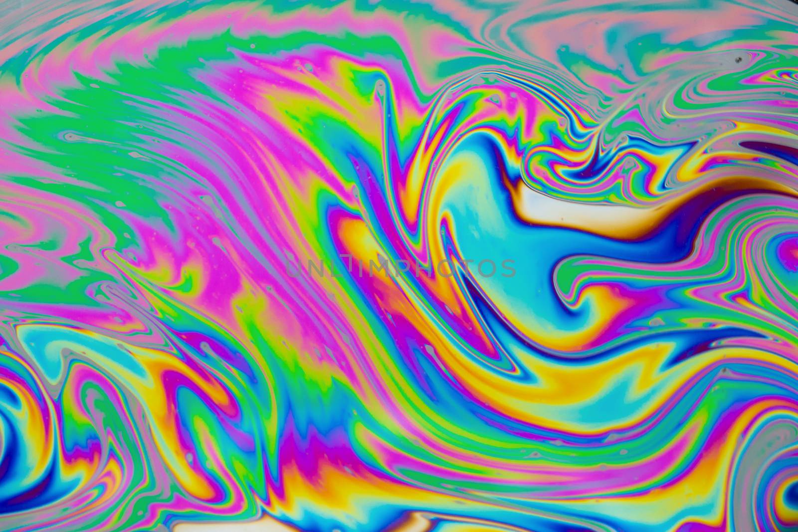 Psychedelic multicolored patterns background. Photo macro shot of soap bubbles