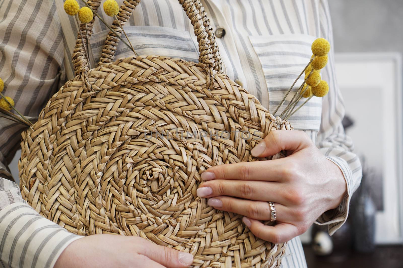 Woman hands with fashionable stylish nude rattan bag and straw bag by natali_brill