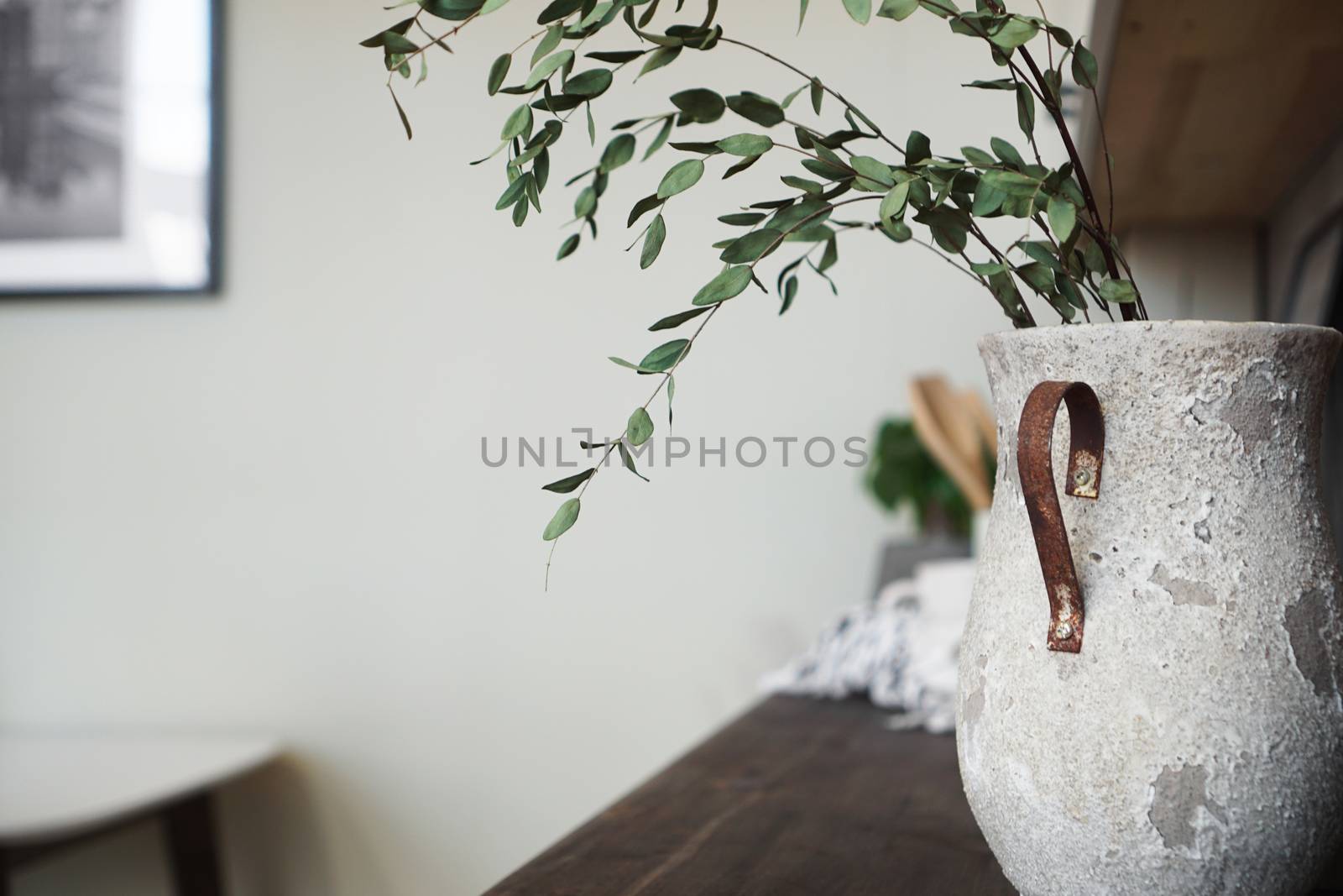 A vase with dry flowers on a table. Scandinavian classic kitchen, minimalistic interior design. Real photo. Cosy home.