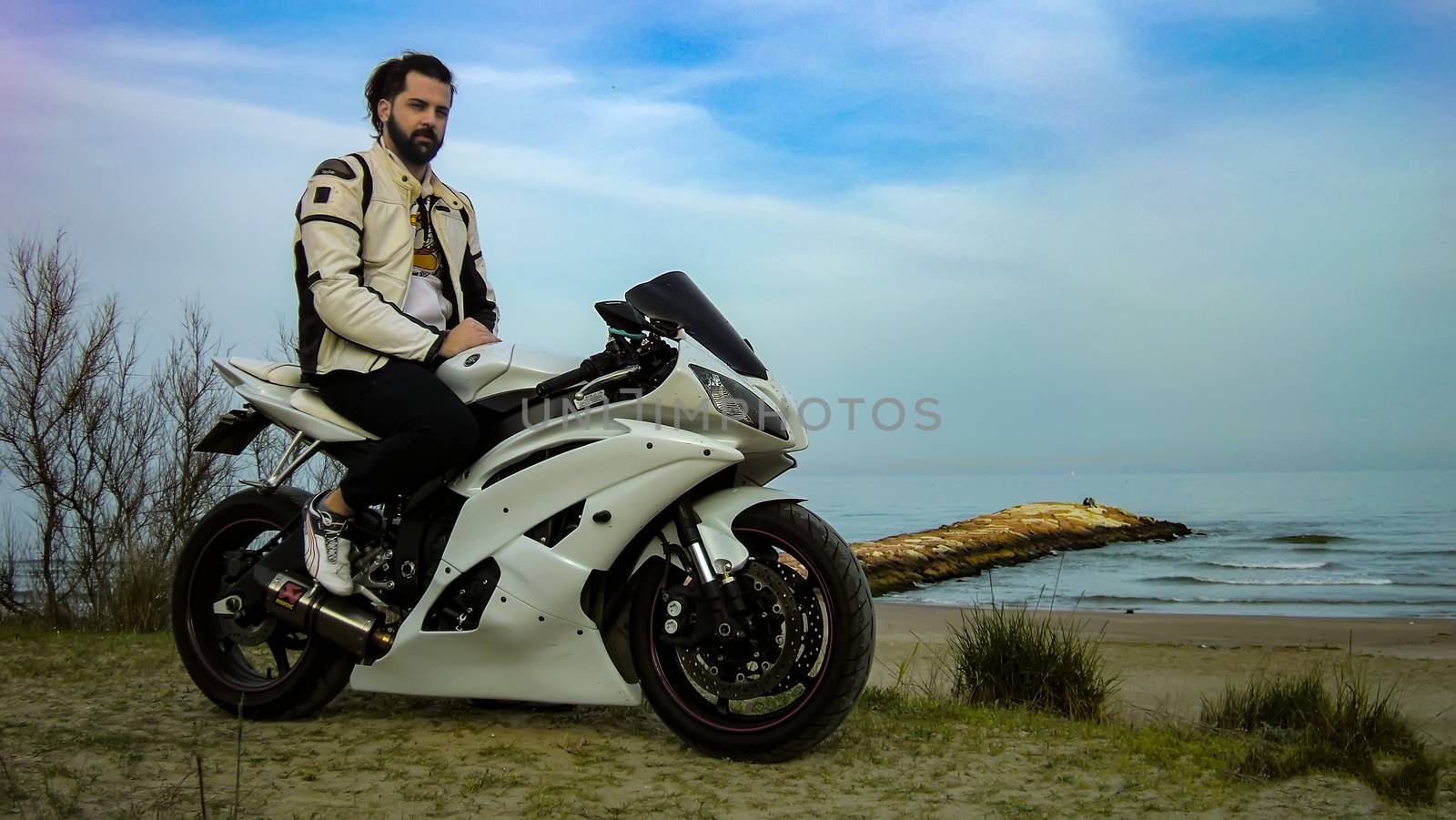 Portrait of a Road biker that rides his motorbike in a beach