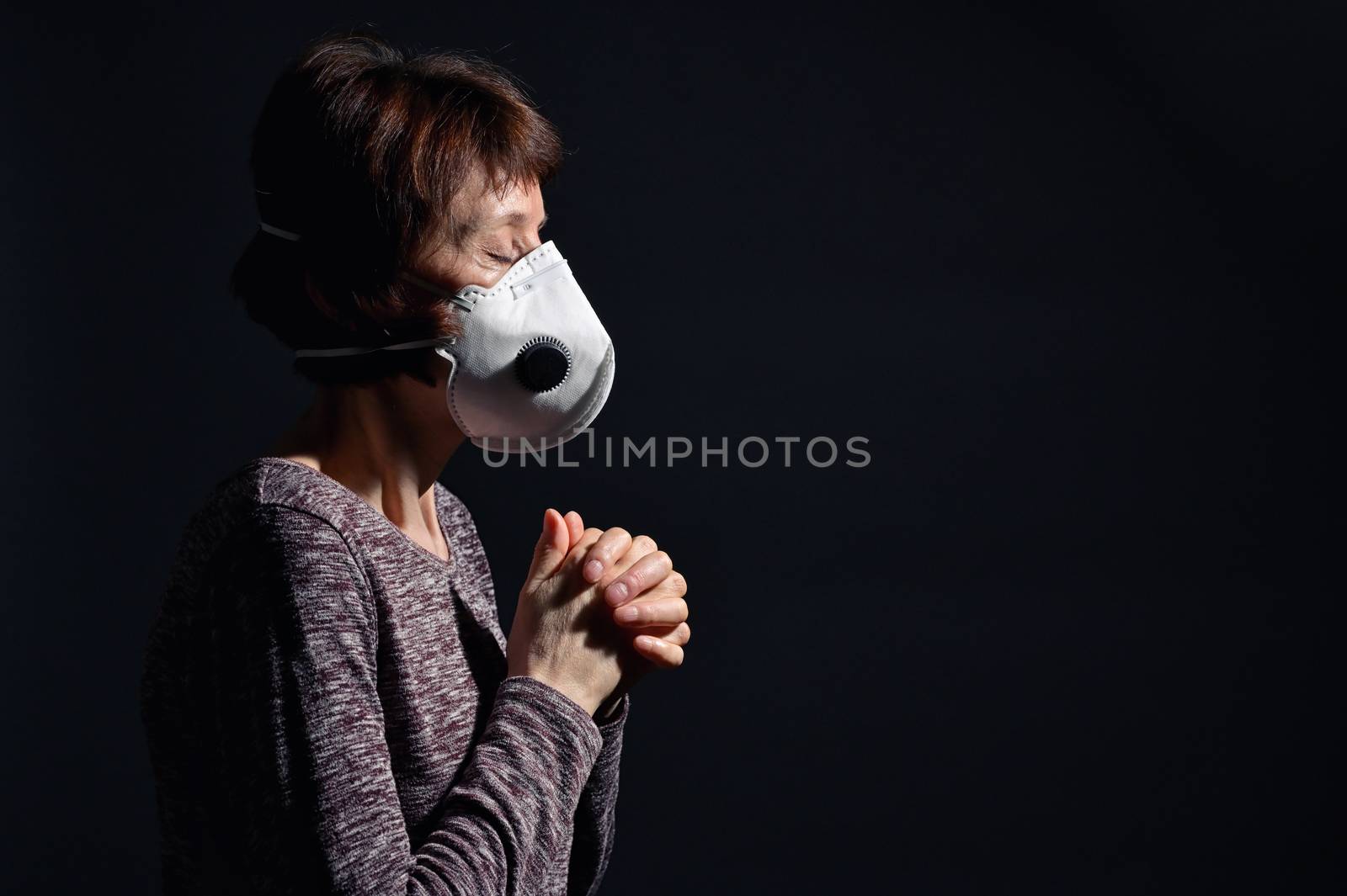 Woman Wearing Medical Protective Virus Mask and pray by mady70