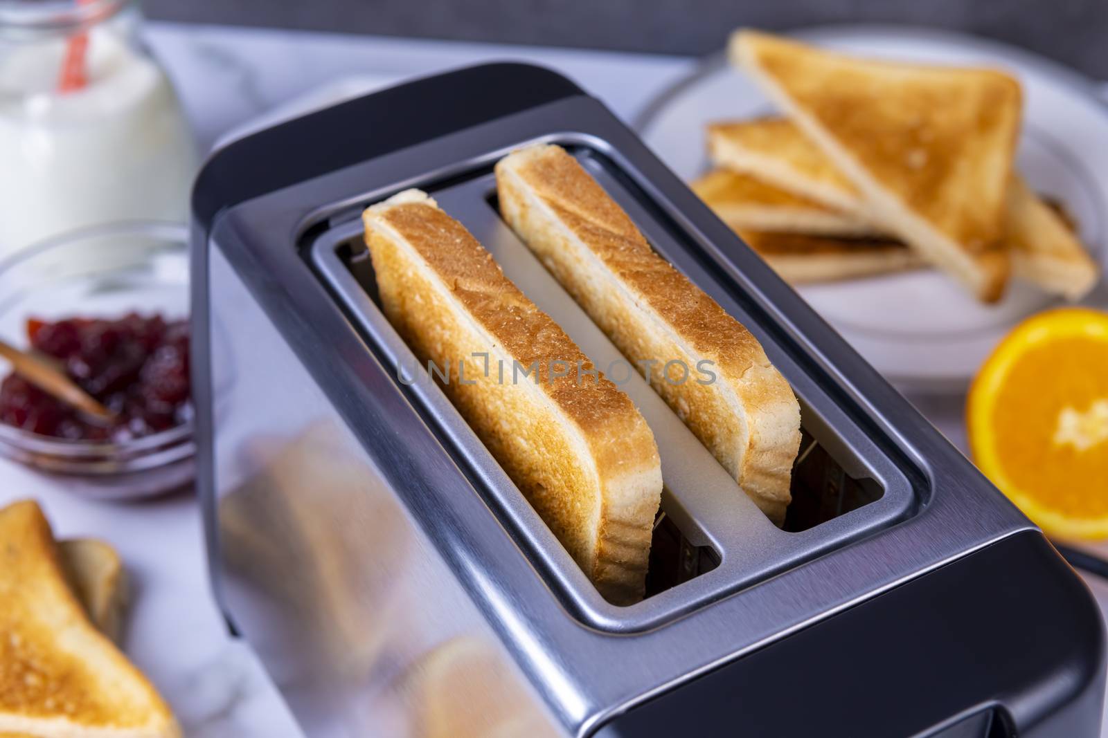 Slices of toast coming out of the toaster for healthy breakfast by manaemedia