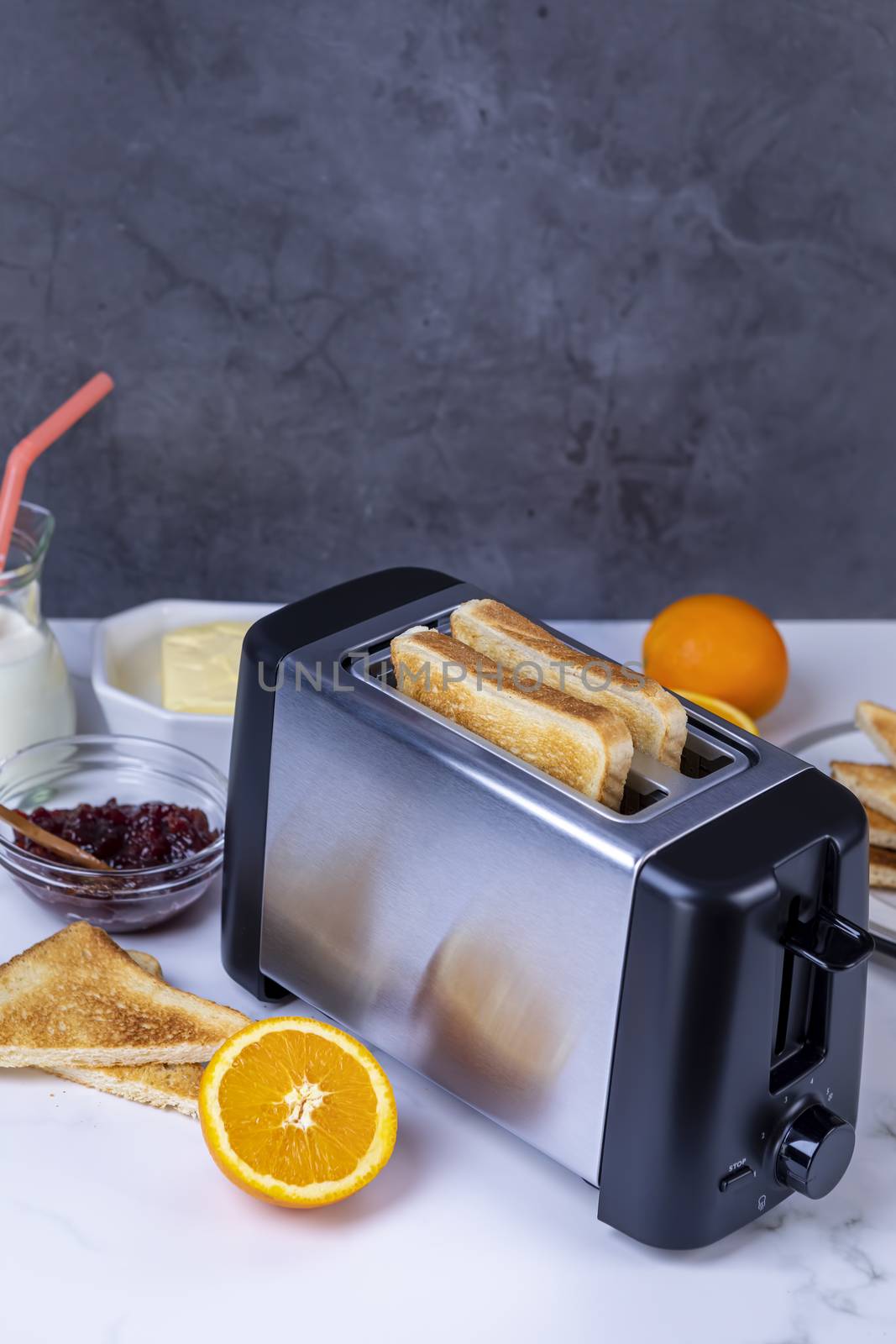 Slices of toast coming out of the toaster for healthy breakfast by manaemedia