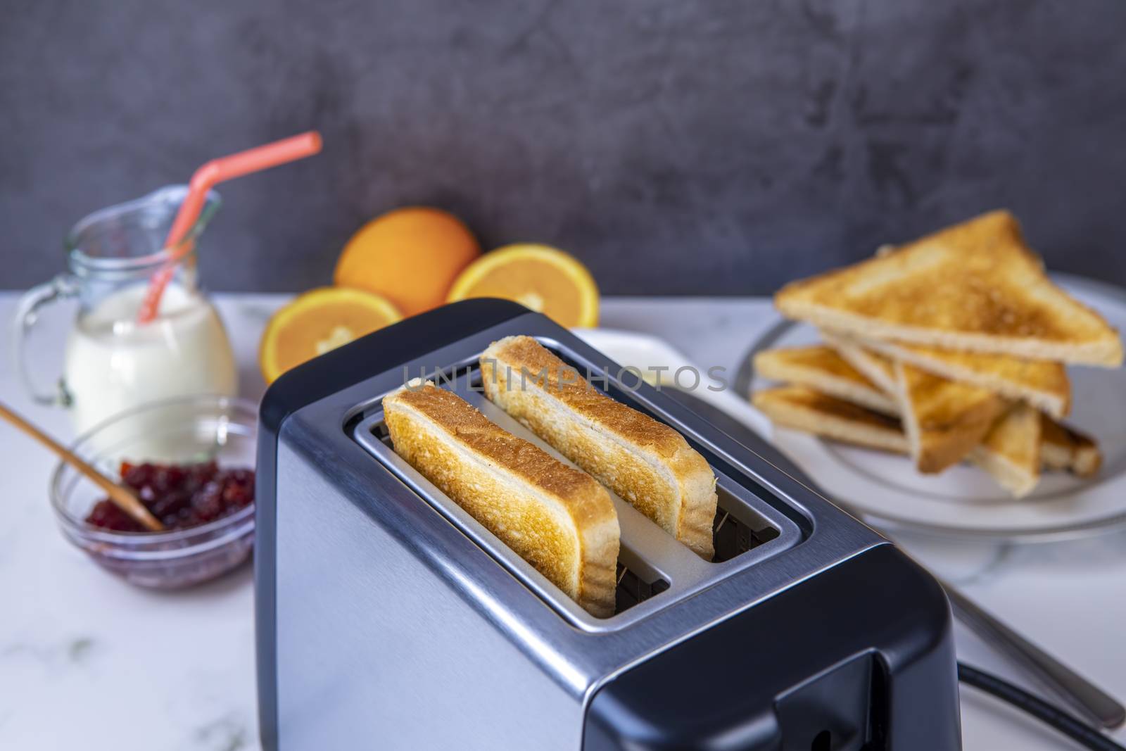 Slices of toast coming out of the toaster for healthy breakfast by manaemedia