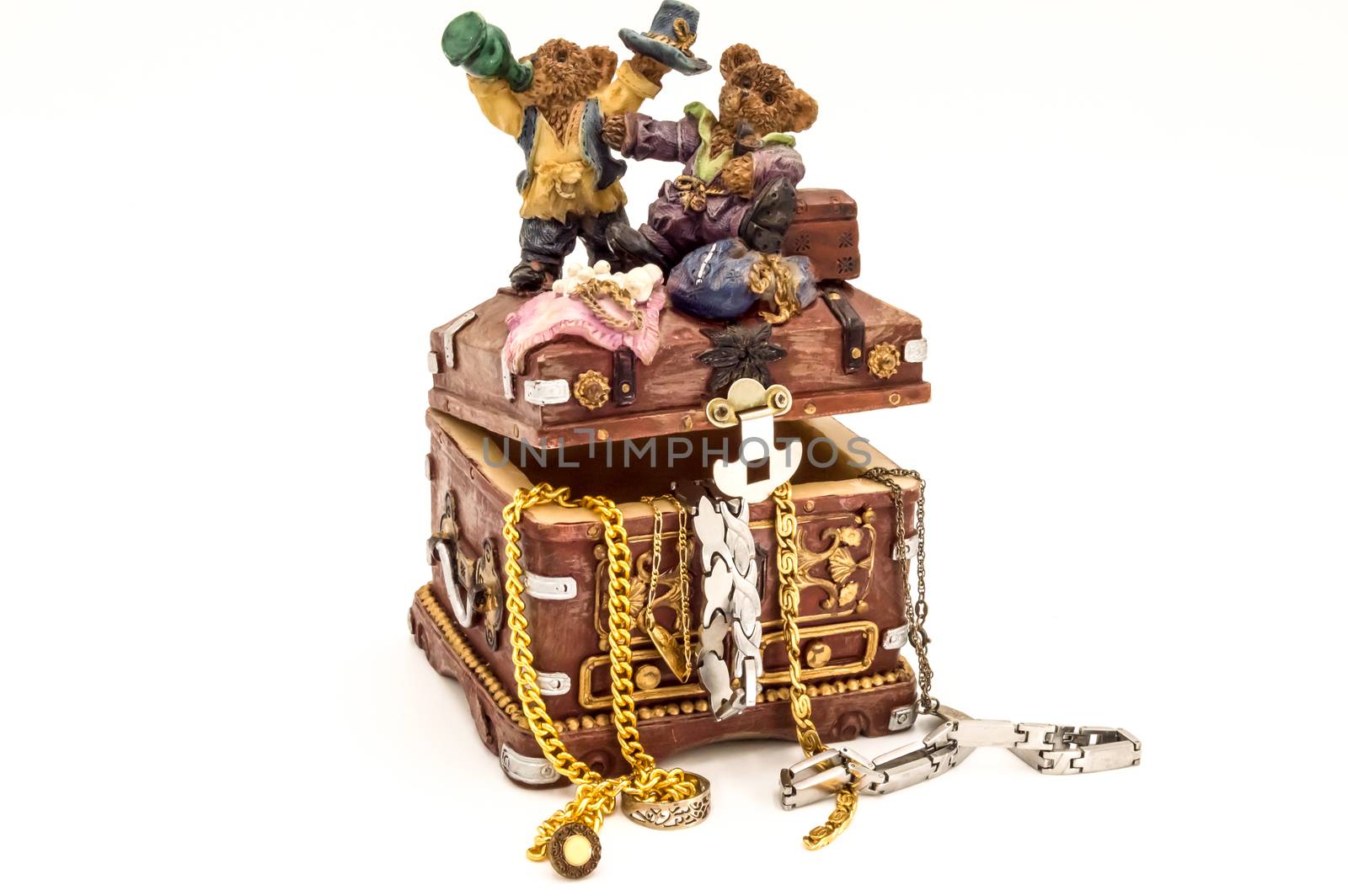 Treasure chest filled with jewelry on white background