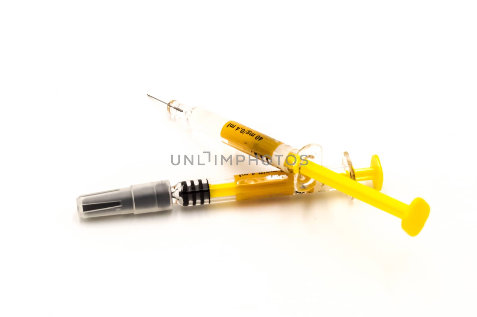 Two syringes close up isolated on white background