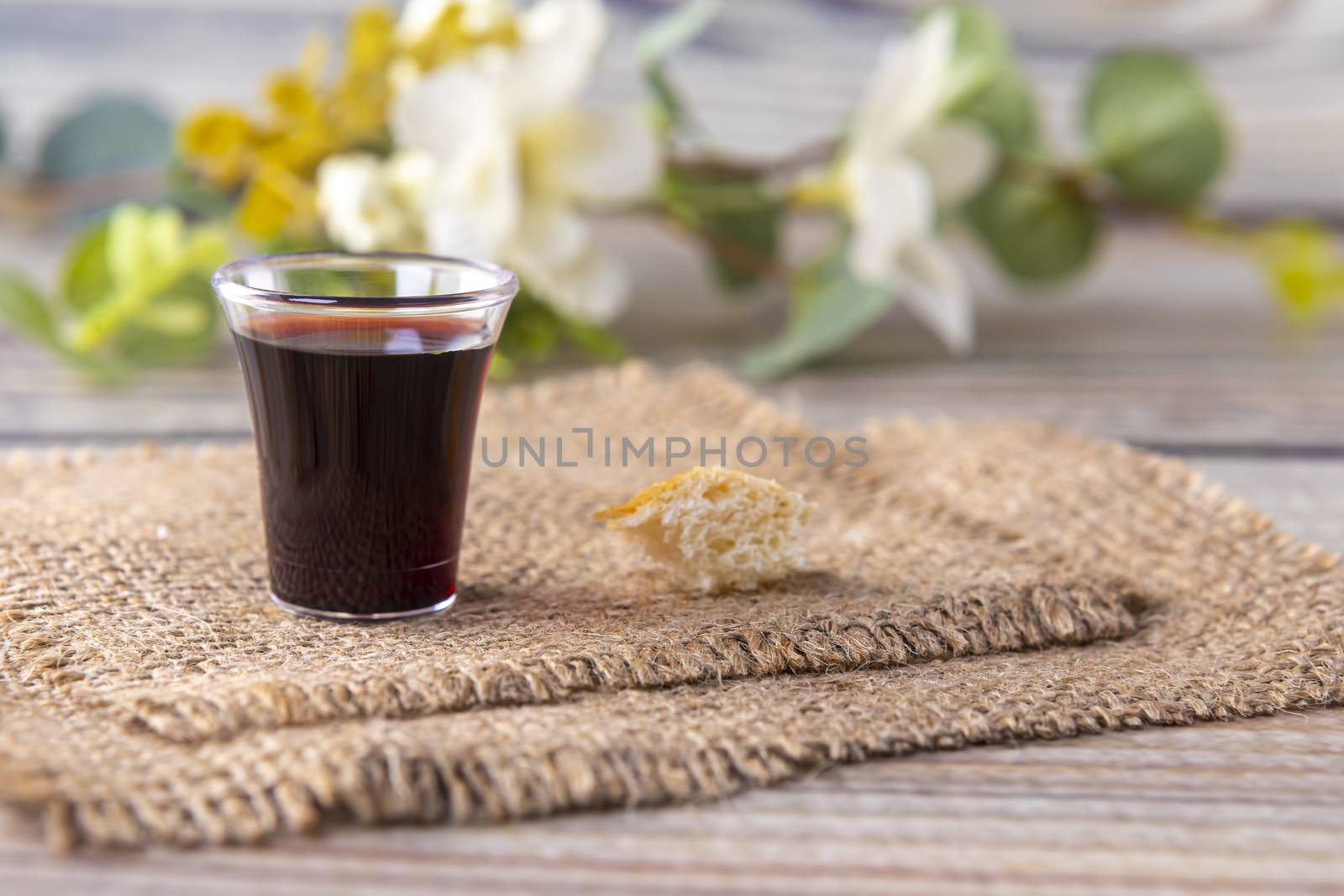 Taking communion concept - the wine and the bread symbols of Jesus Christ blood and body. Easter Passover and Lord . Focus on glass.