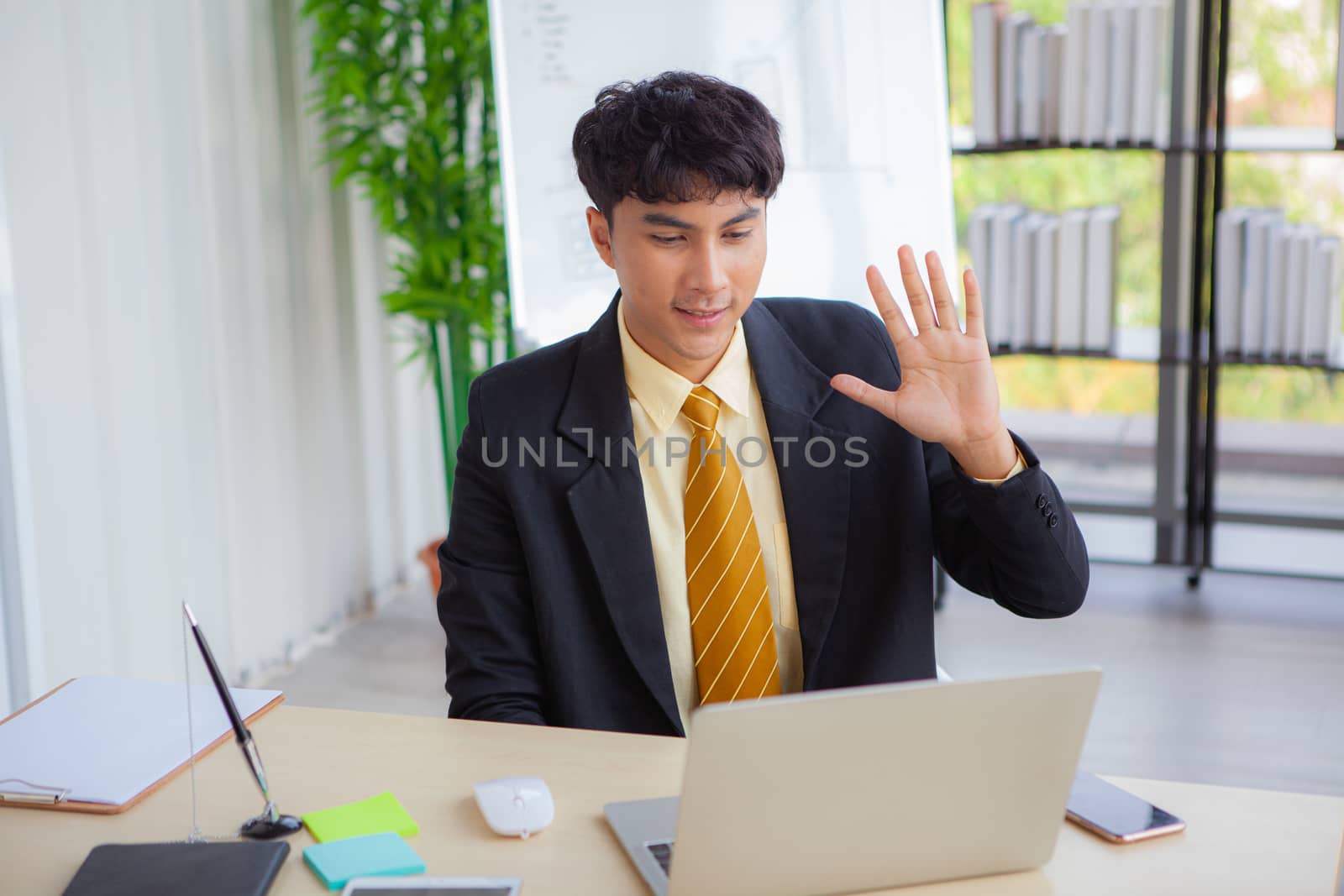 Young businessmen are greeting business partners on a computer s by panyajampatong