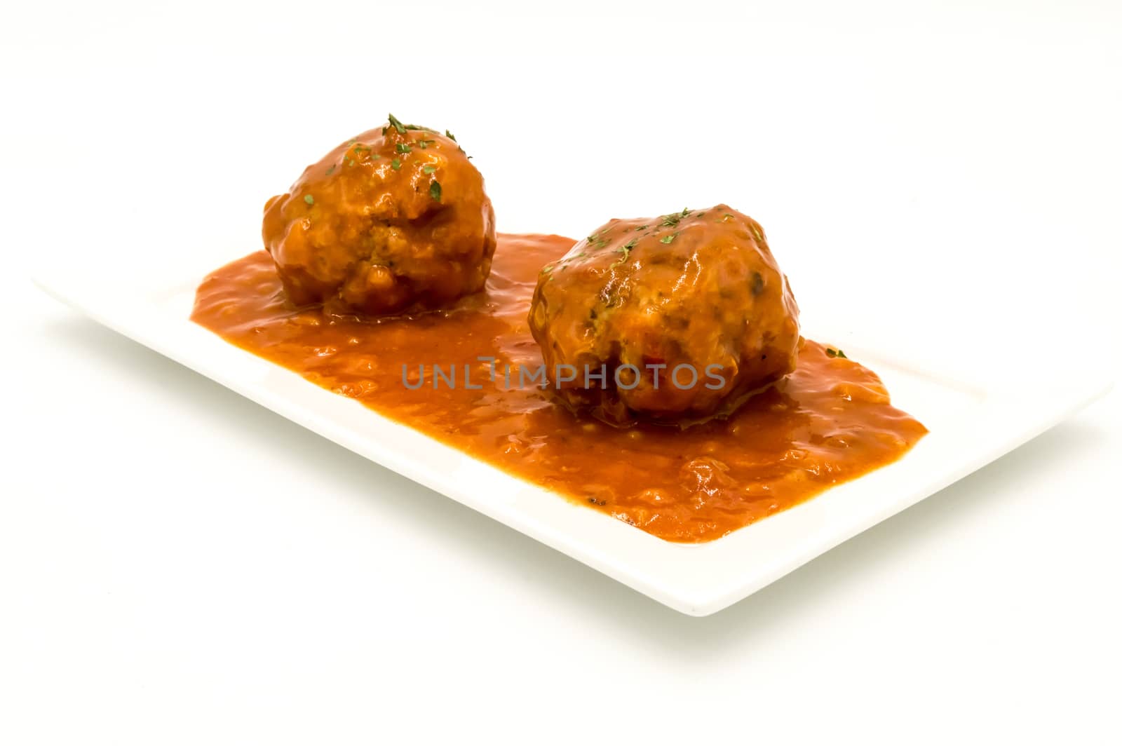 Meatballs cooked in tomato sauce on a white background