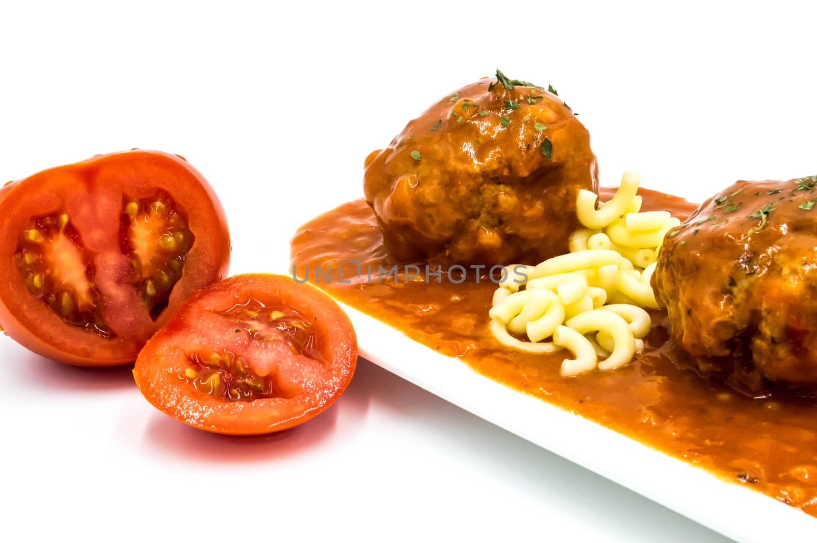 Meatballs cooked in tomato sauce with small pasta on white background