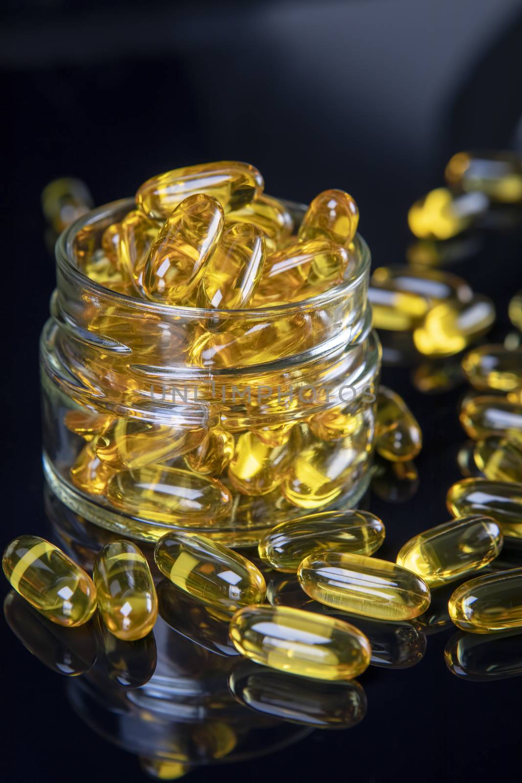 Omega fish oil softgels dietary supplement in jar. Healthy life and heart health concept.