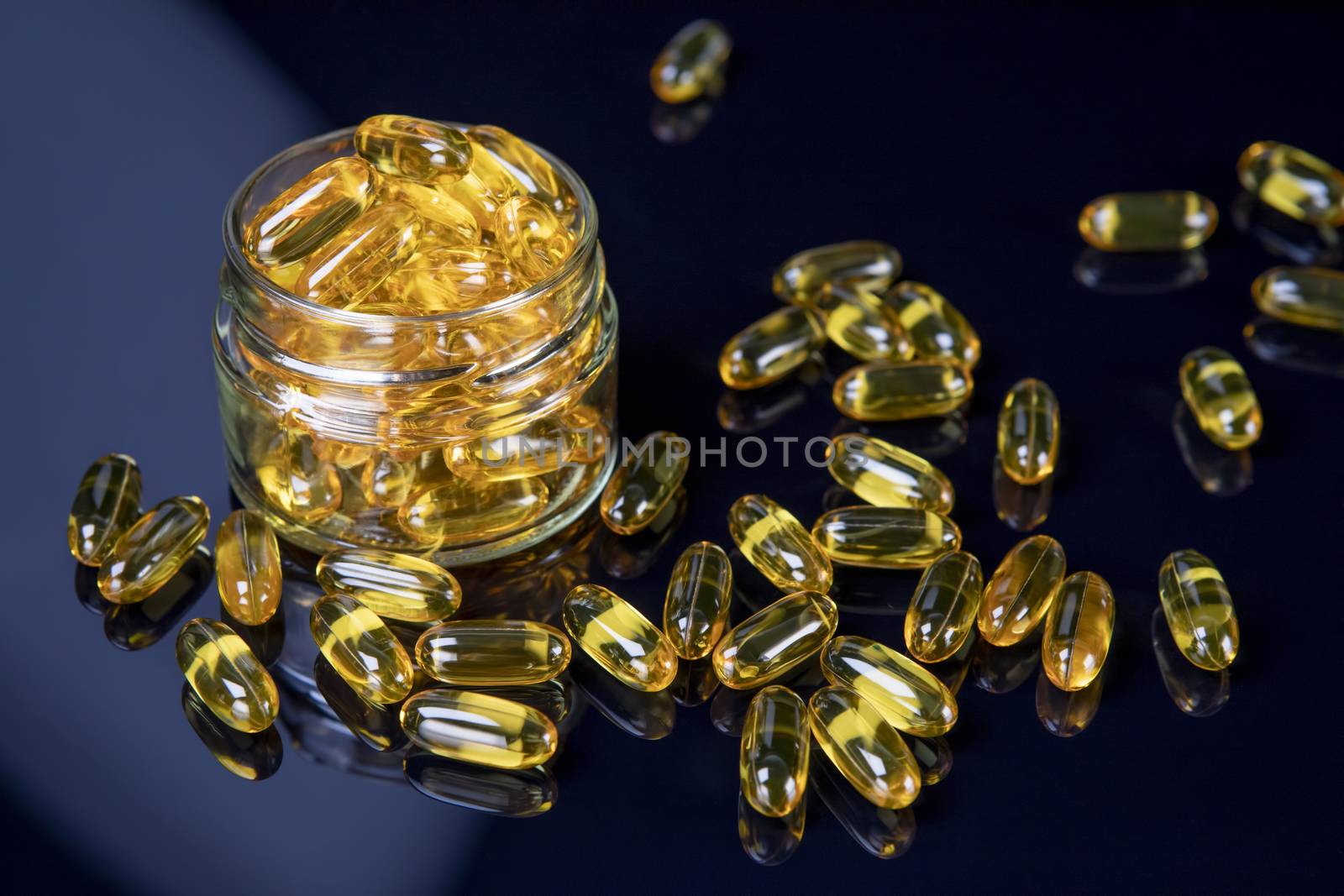 Omega fish oil softgels dietary supplement in jar. Healthy life and heart health concept. Focus on pills in jar