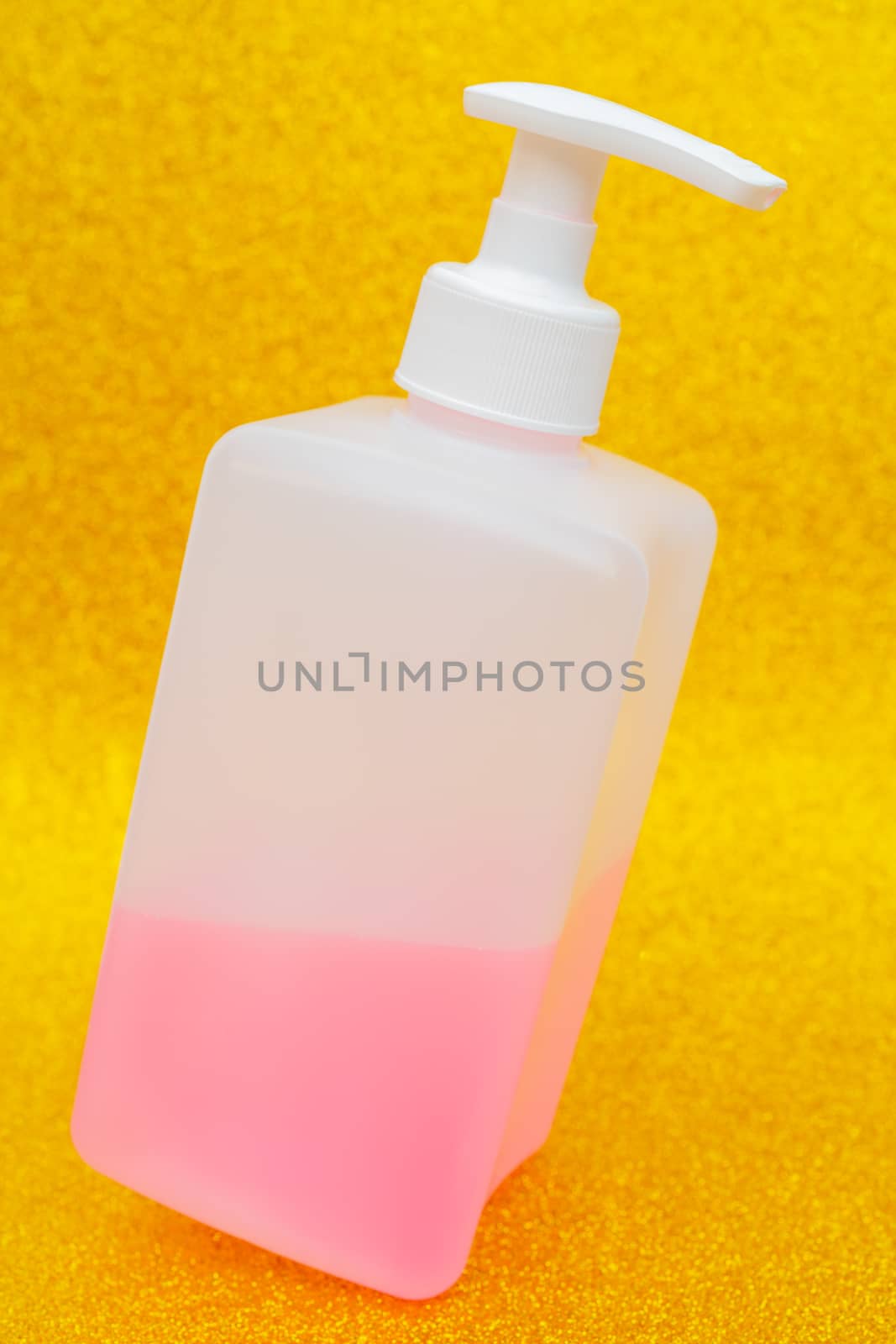 Antibacterial disinfectant soap. Liquid pink soap in white bottle.