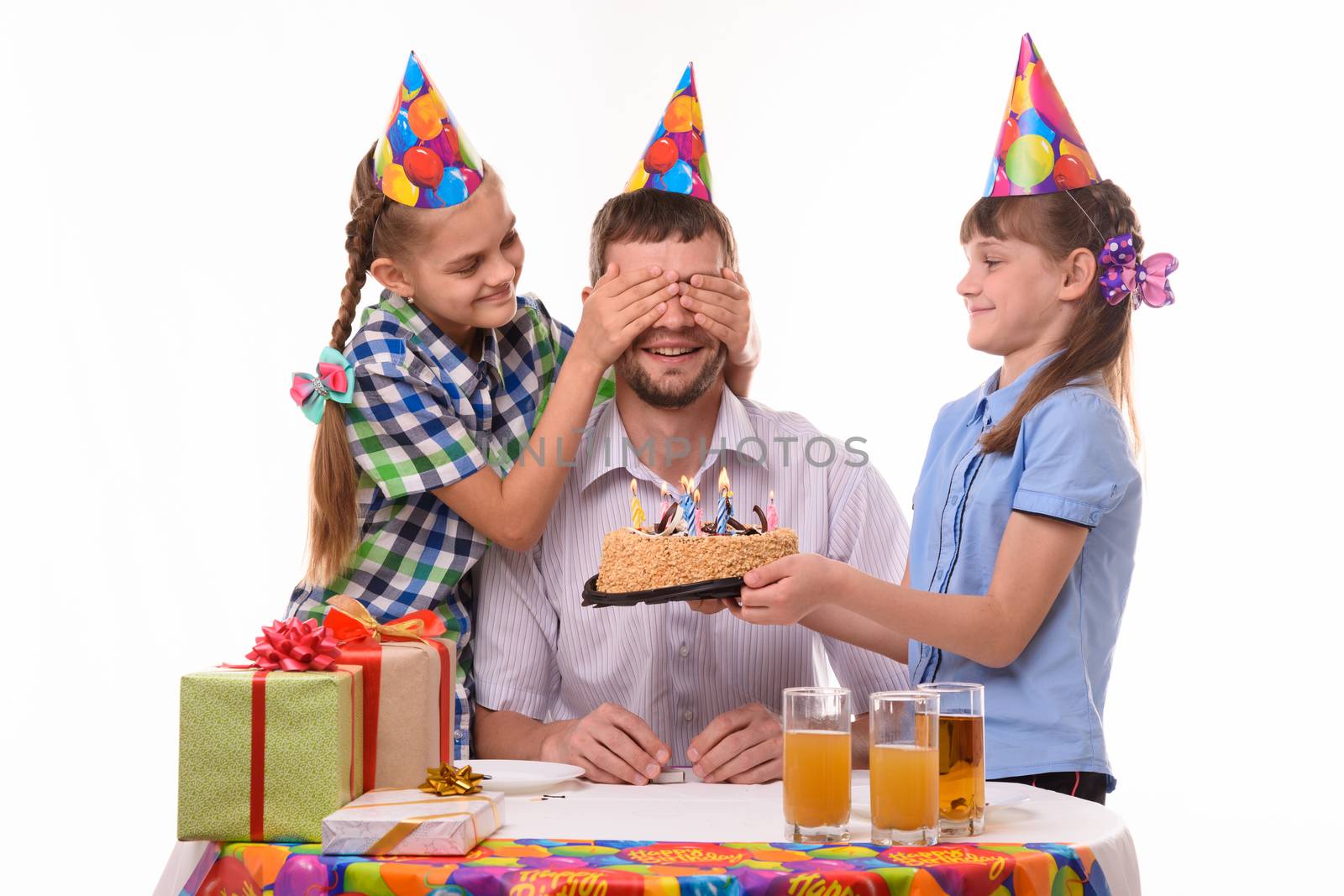 Children give a sweet surprise to dad at a birthday party