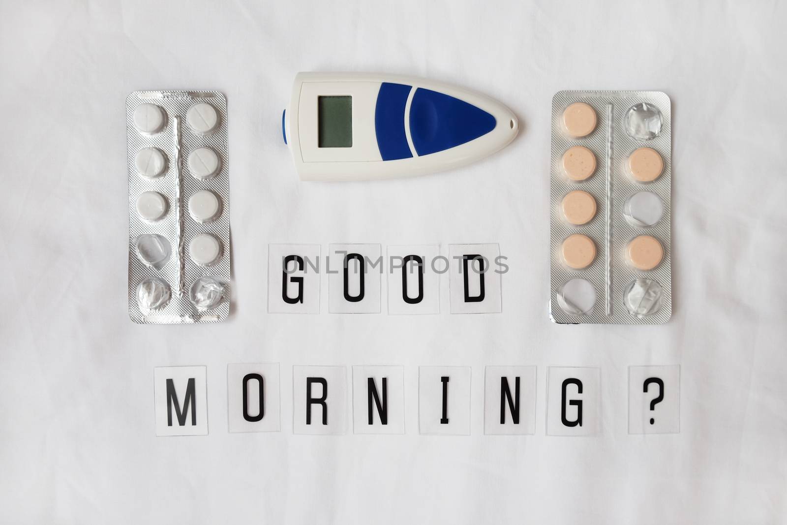 Inscription question Good morning, pills, thermometer on crumpled white sheet. Awakening concept with headache, fever, medicine, illness, health, hangover, migraine. Horizontal, flat lay by ALLUNEED