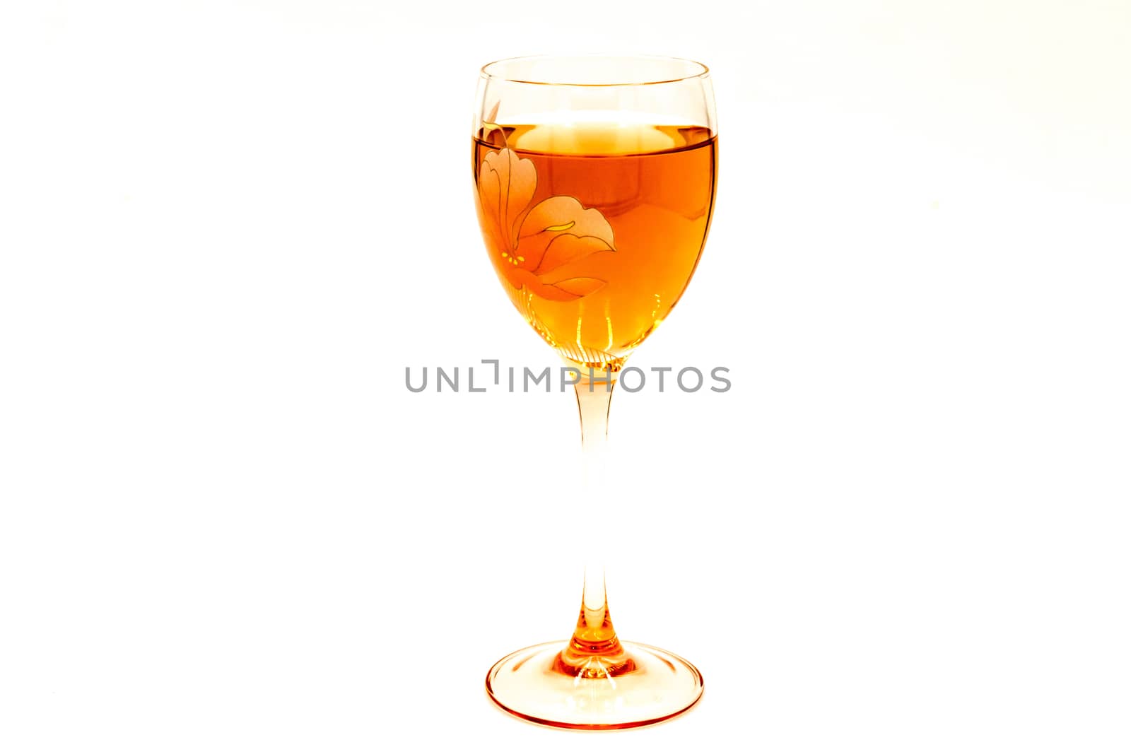 Glass of rose wine with a flower burn on a white background