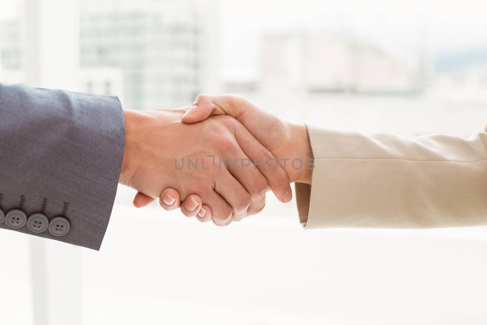 Close-up of business people shaking hands in the office