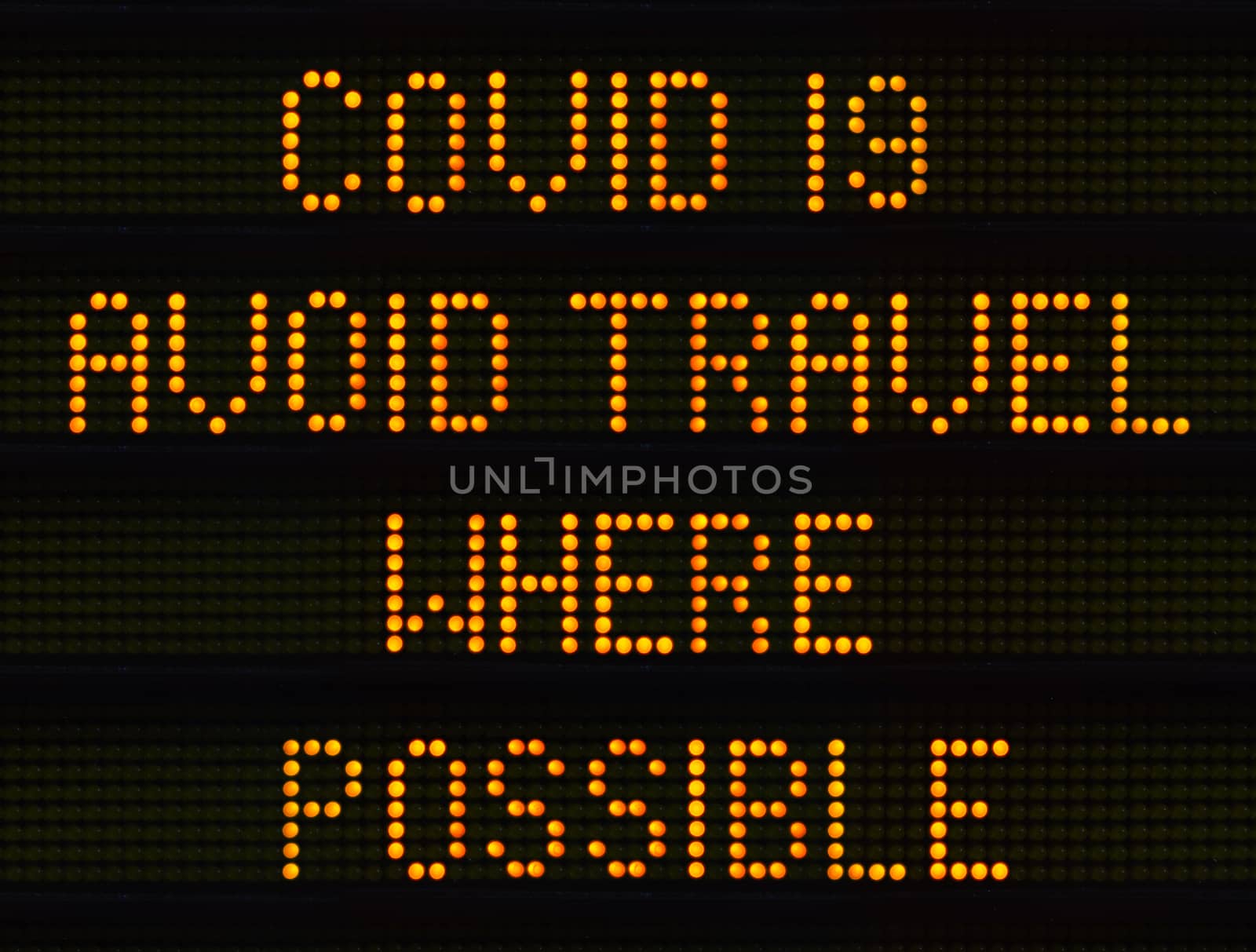 A UK Traffic Sign Warning Drivers To Avoid Travel Where Possible During The COVID-19, Or Coronavirus, Pandemic