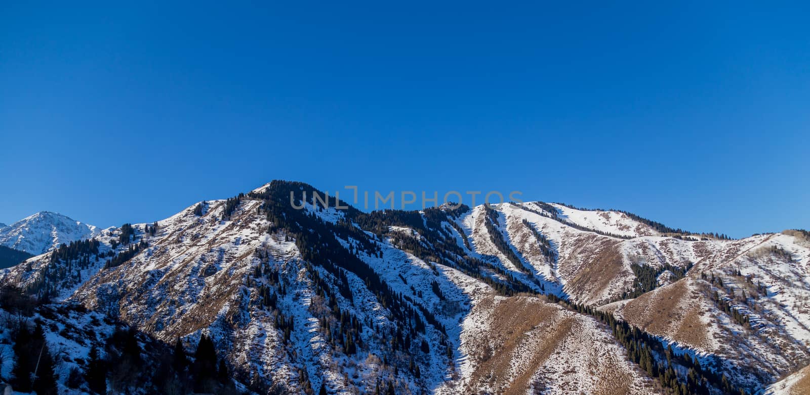 Winter Snowy Mountains valley with sun in Ak Bulak, Almaty, Kazakhstan, Asia