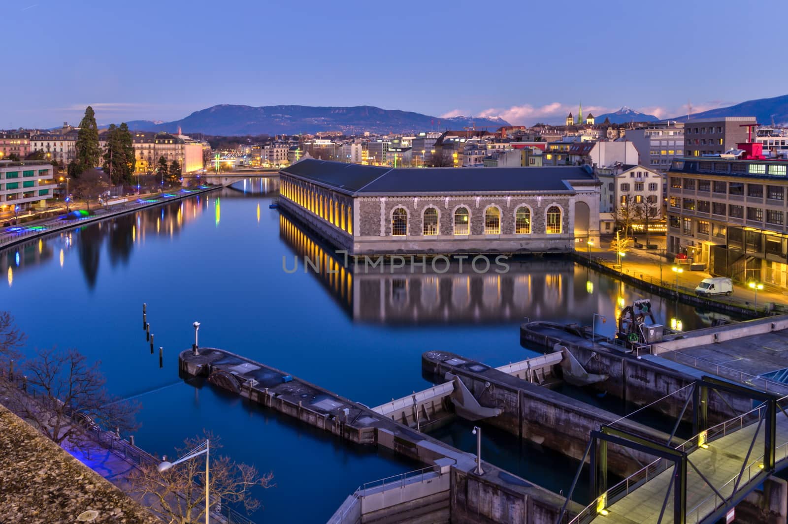 BFM, cathedral Saint-Pierre green tower and Rhone river by night with full moon, Geneva, Switzerland, HDR