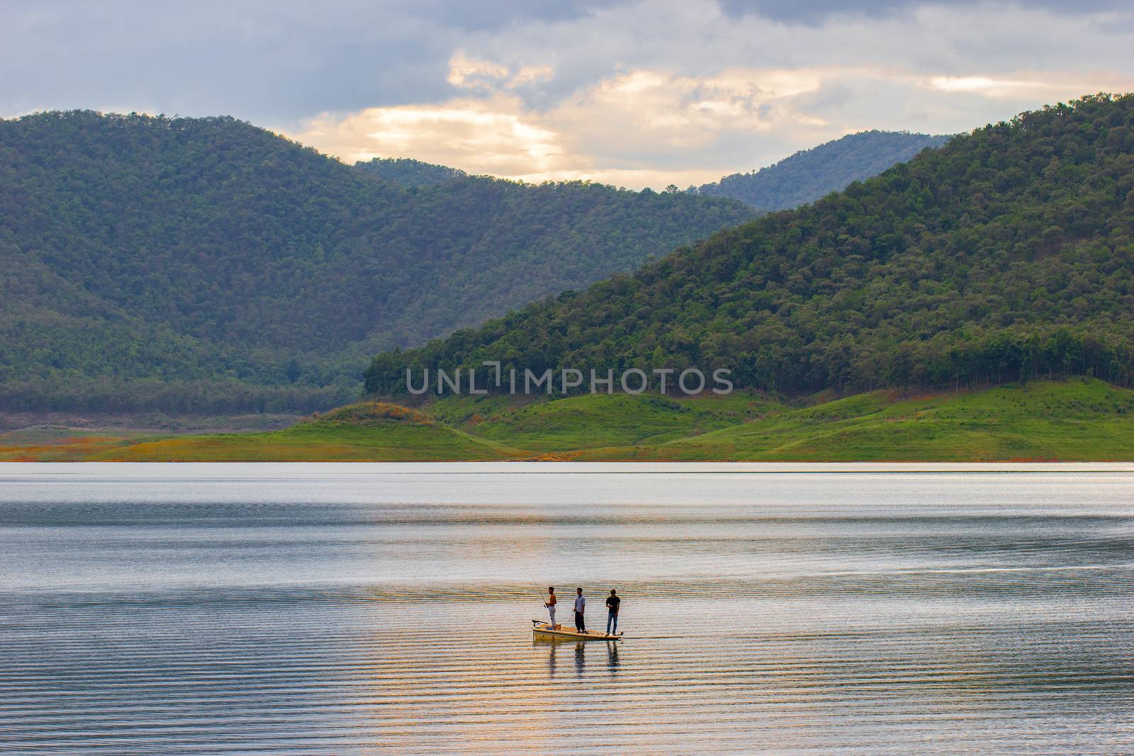 Three men standing on the boat and fishing. by SaitanSainam