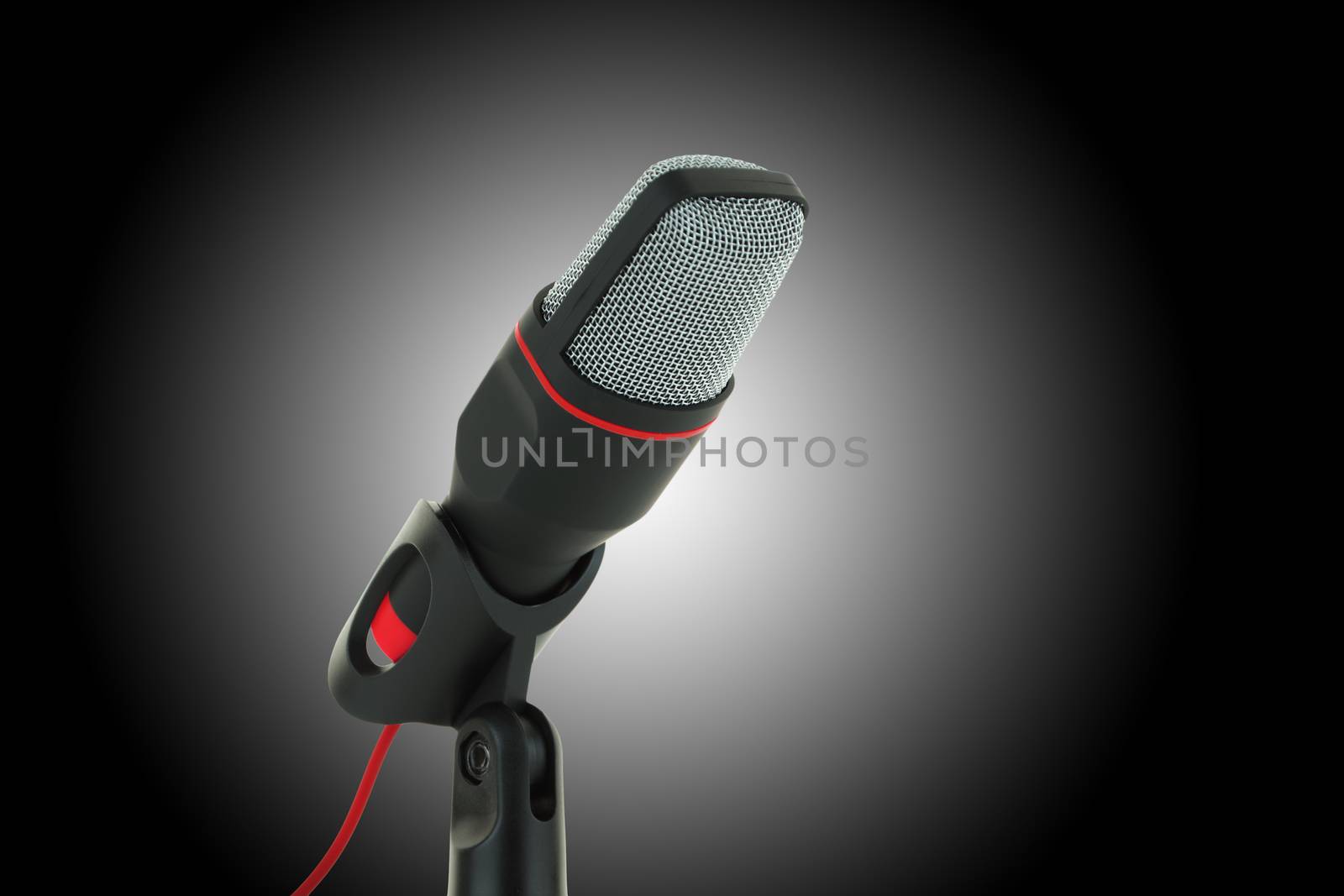 A black and red microphone on dark background