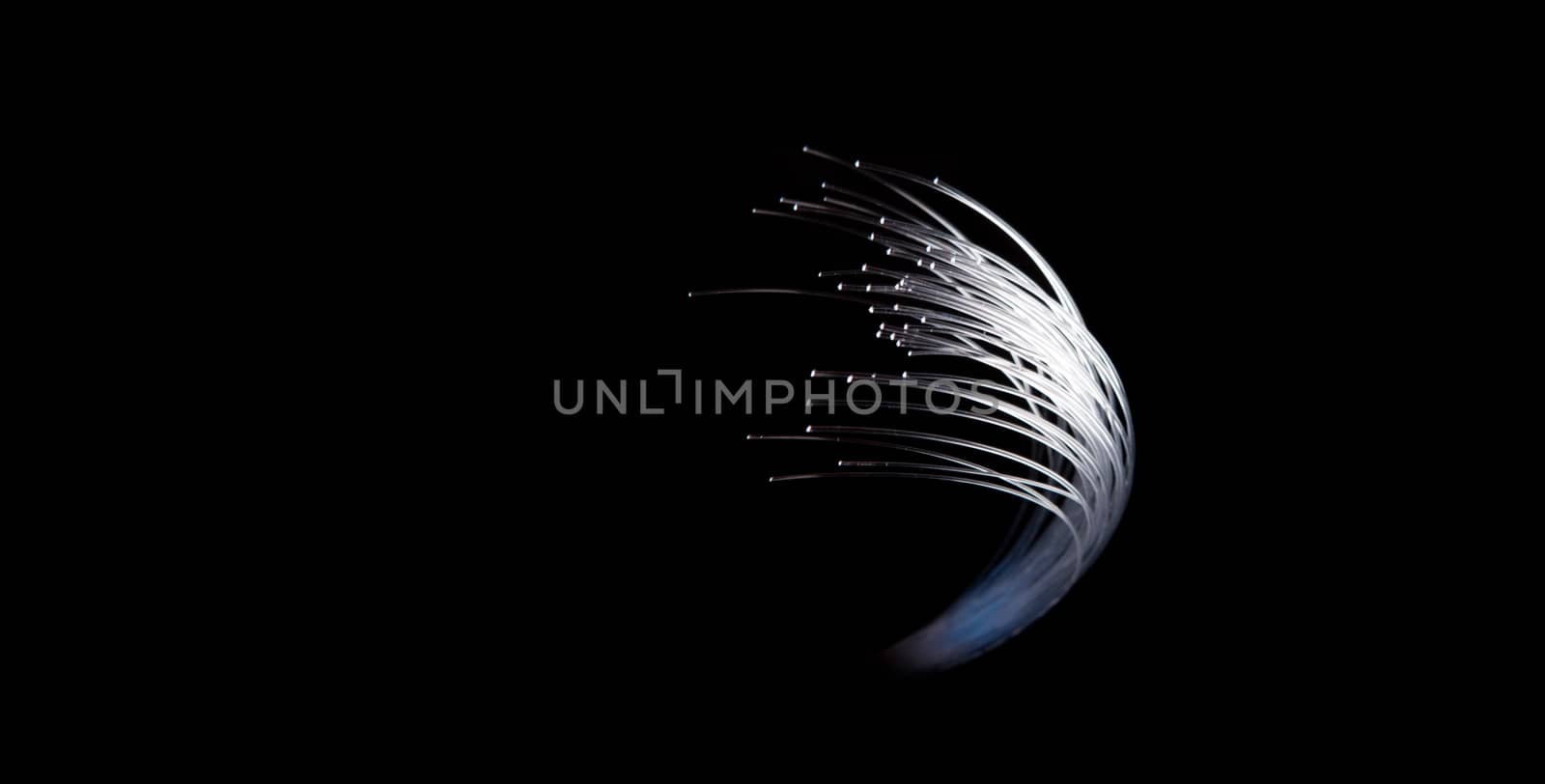 fibered optics glowing wire on black background with copy space by PeterHofstetter