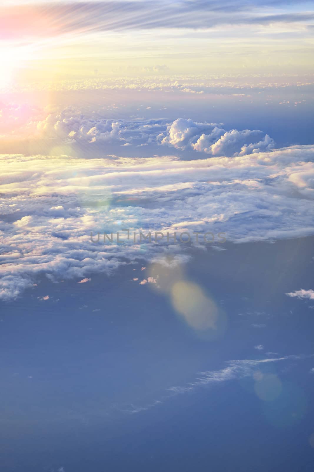 dramatic cloudscape with dramatic clouds reflecting the rays of sunset light.