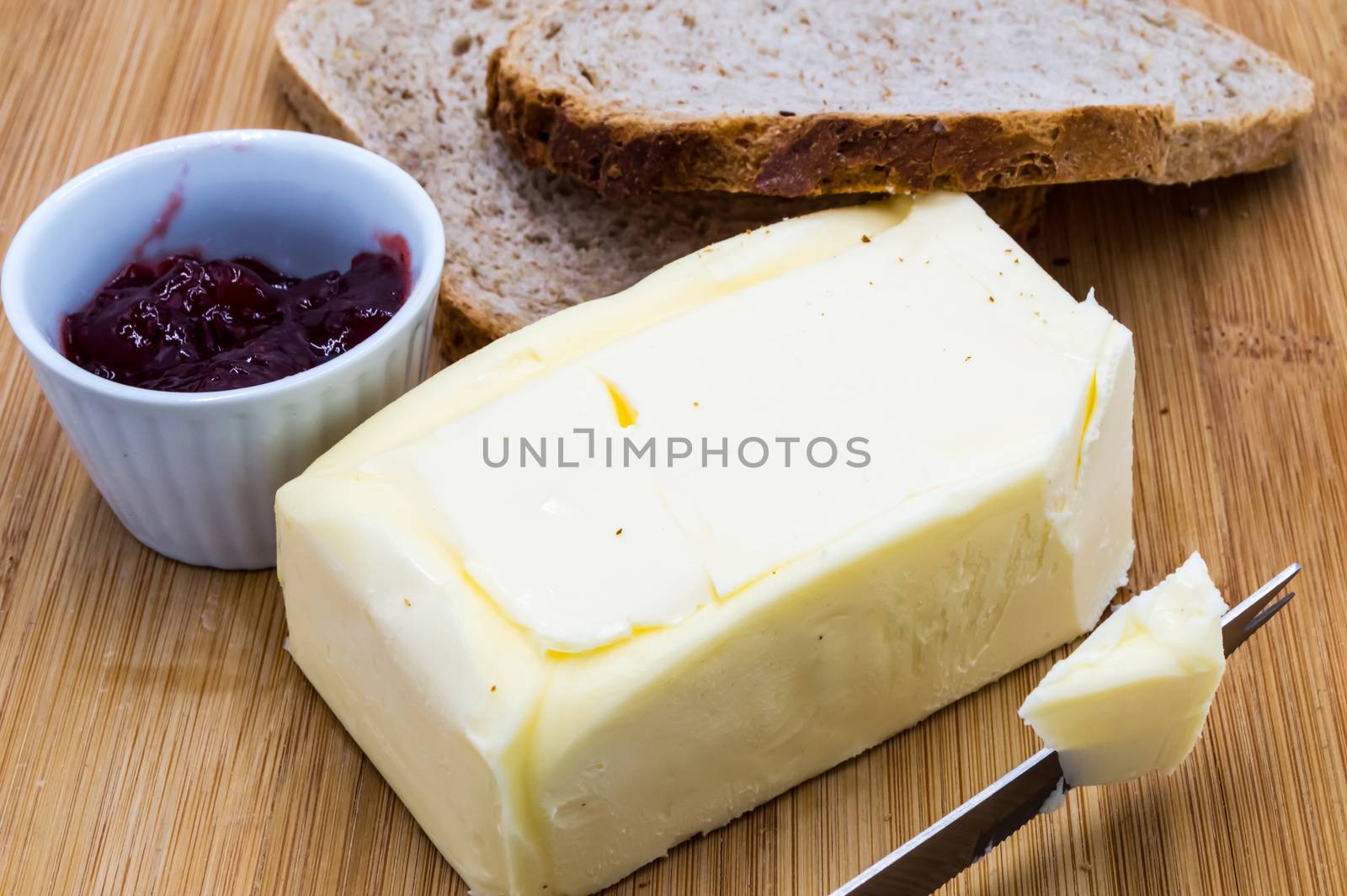 Block of fresh rectangular butter with jam  by Philou1000