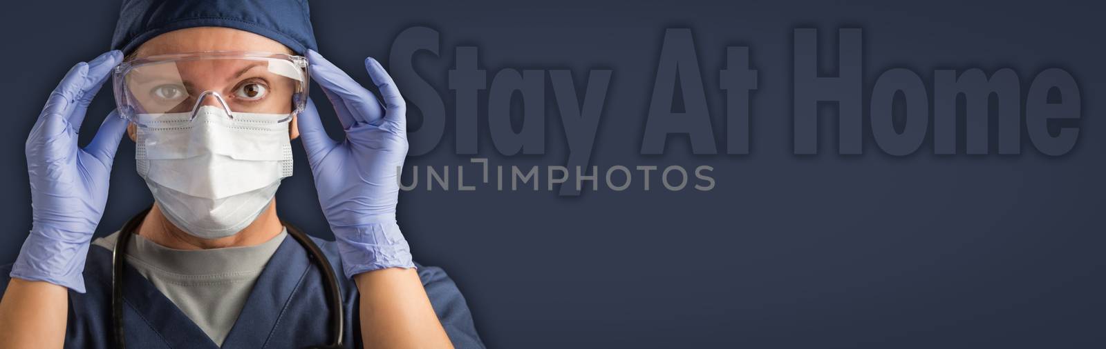 Banner of Female Doctor or Nurse In Medical Face Mask and Protective Gear With Stay At Home Text Behind. by Feverpitched