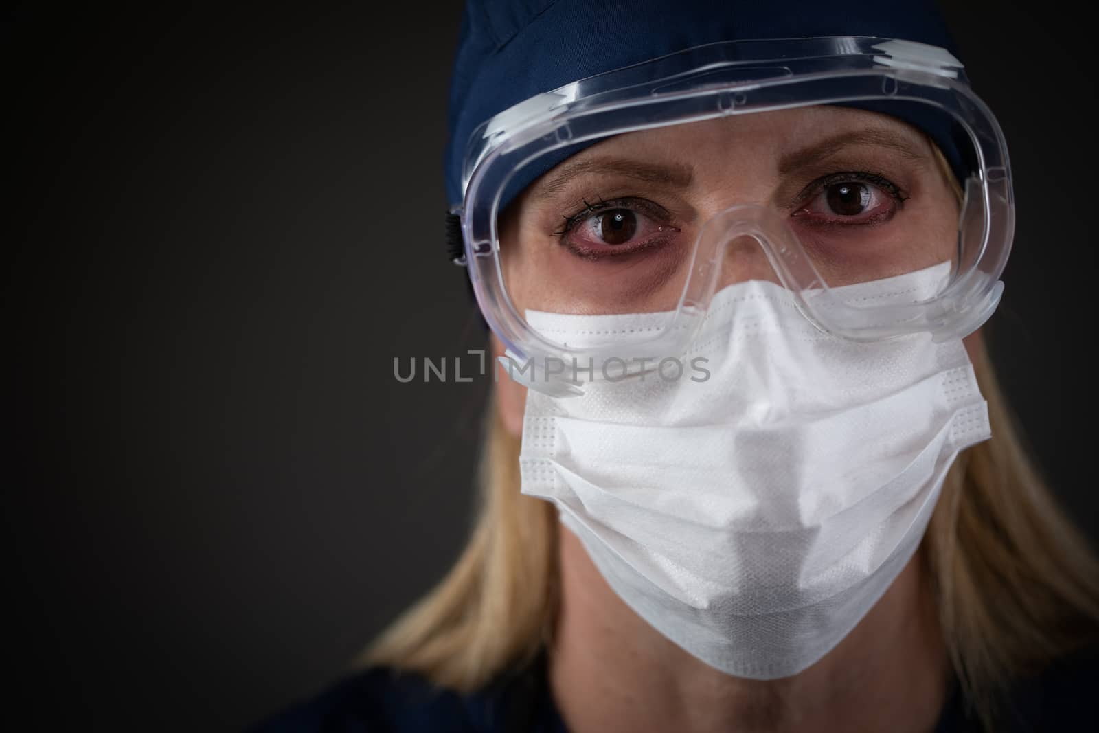 Female Medical Worker Wearing Protective Gear Showing Symptoms of Disease. by Feverpitched