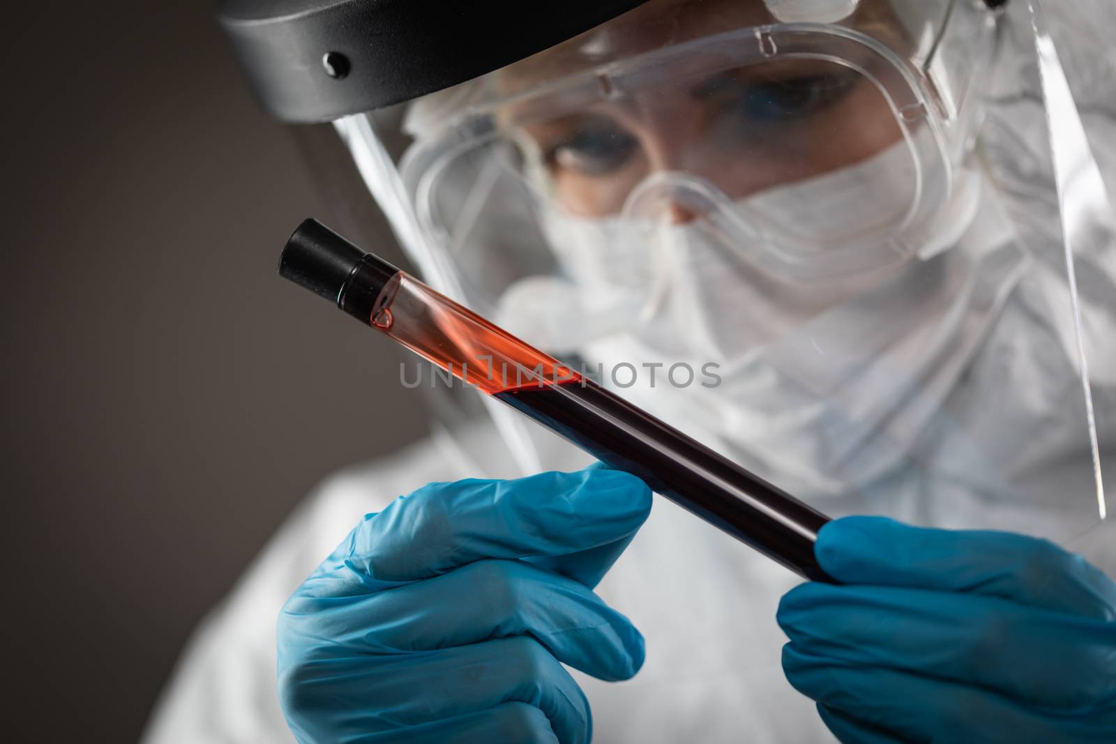 Female Lab Worker Holds Test Tube of Blood For Testing.