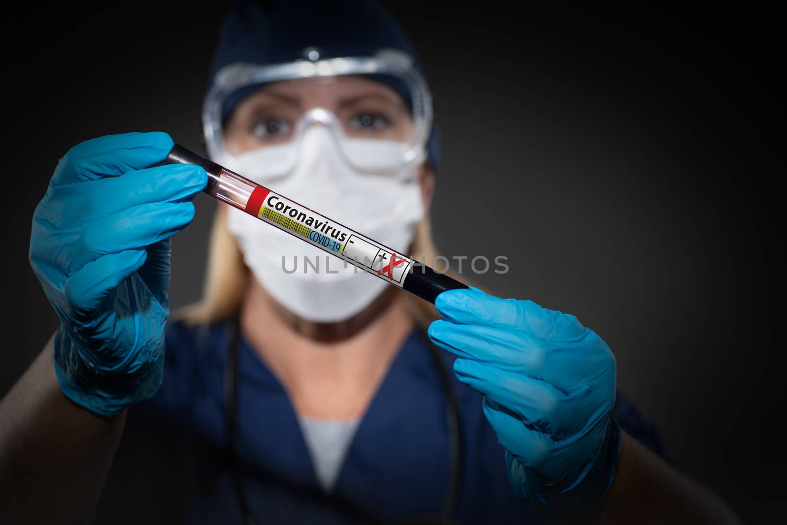 Female Lab Worker Holds Test Tube of Blood Labeled Coronavirus COVID-19 Disease. by Feverpitched