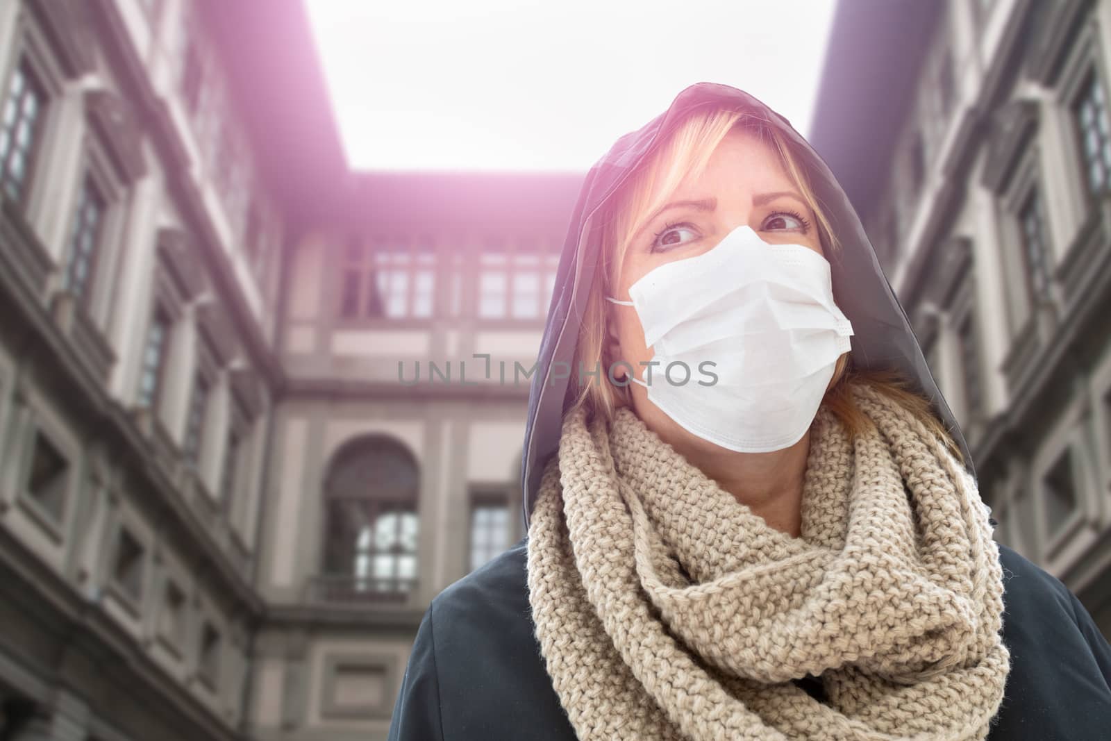 Young Woman Wearing Face Mask Walks Near the Uffizi Gallery In Italy.