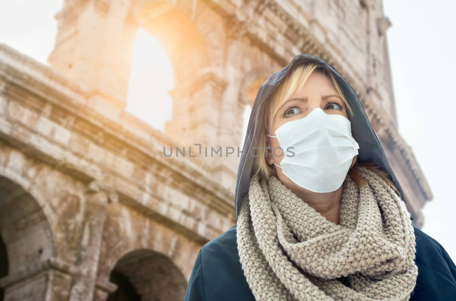 Young Woman Wearing Face Mask Walks Near the The Roman Coliseum In Rome, Italy. by Feverpitched