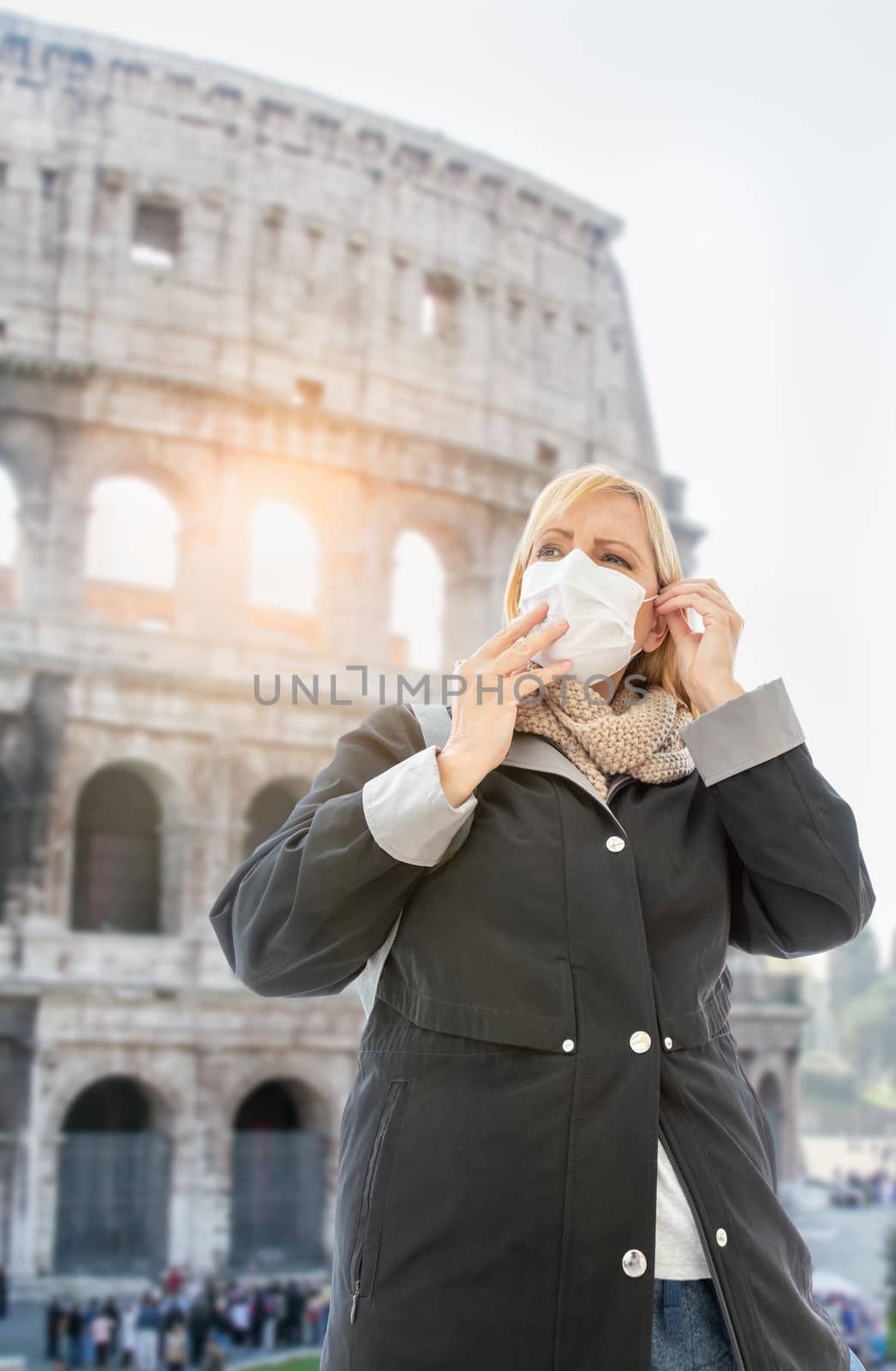 Young Woman Wearing Face Mask Walks Near the The Roman Coliseum  by Feverpitched