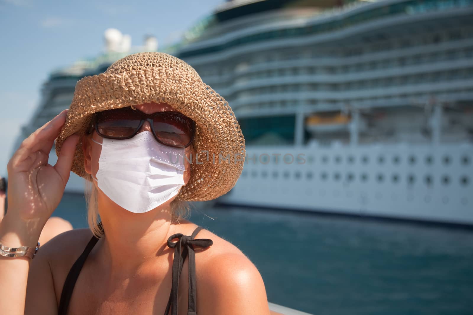 Young Adult Woman Wearing Face Mask on Tender Boat With Passenger Cruise Ship Behind..