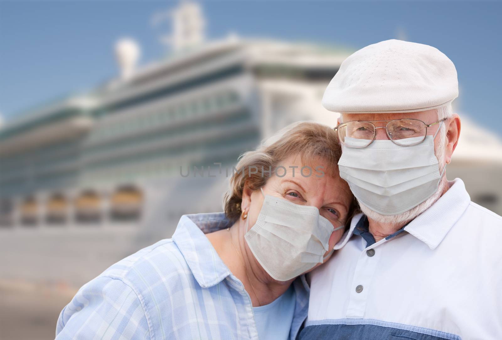 Senior Couple Wearing Face Masks Standing In Front of Passenger Cruise Ship. by Feverpitched