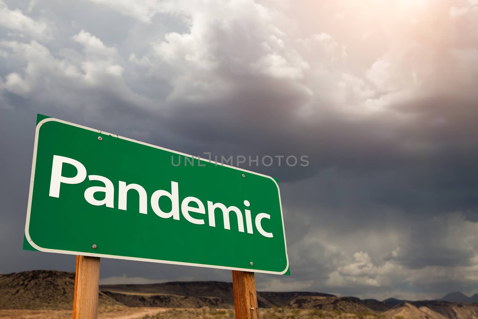 Pandemic Green Road Sign Against Ominous Stormy Cloudy Sky by Feverpitched
