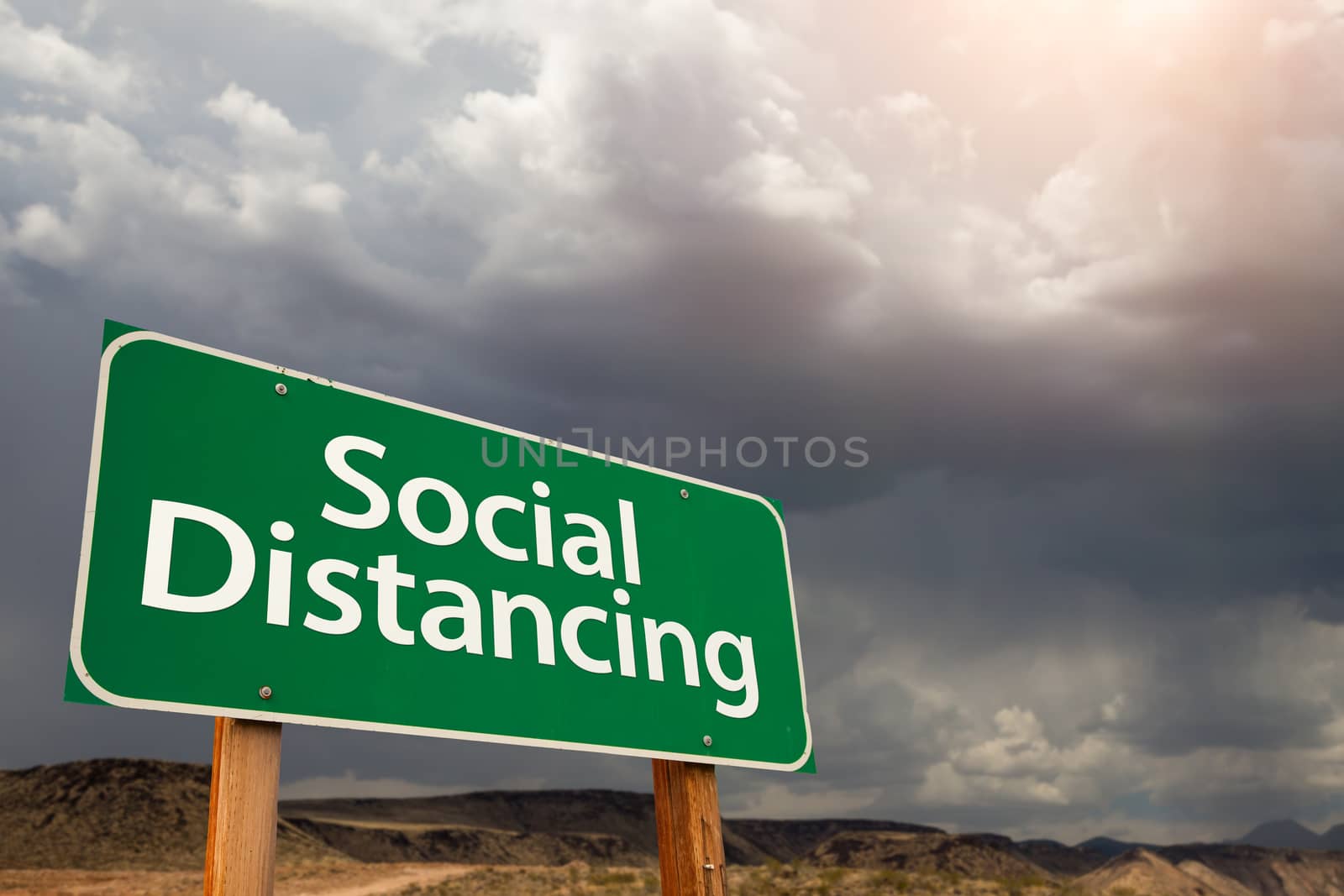 Social Distancing Green Road Sign Against Ominous Stormy Cloudy  by Feverpitched