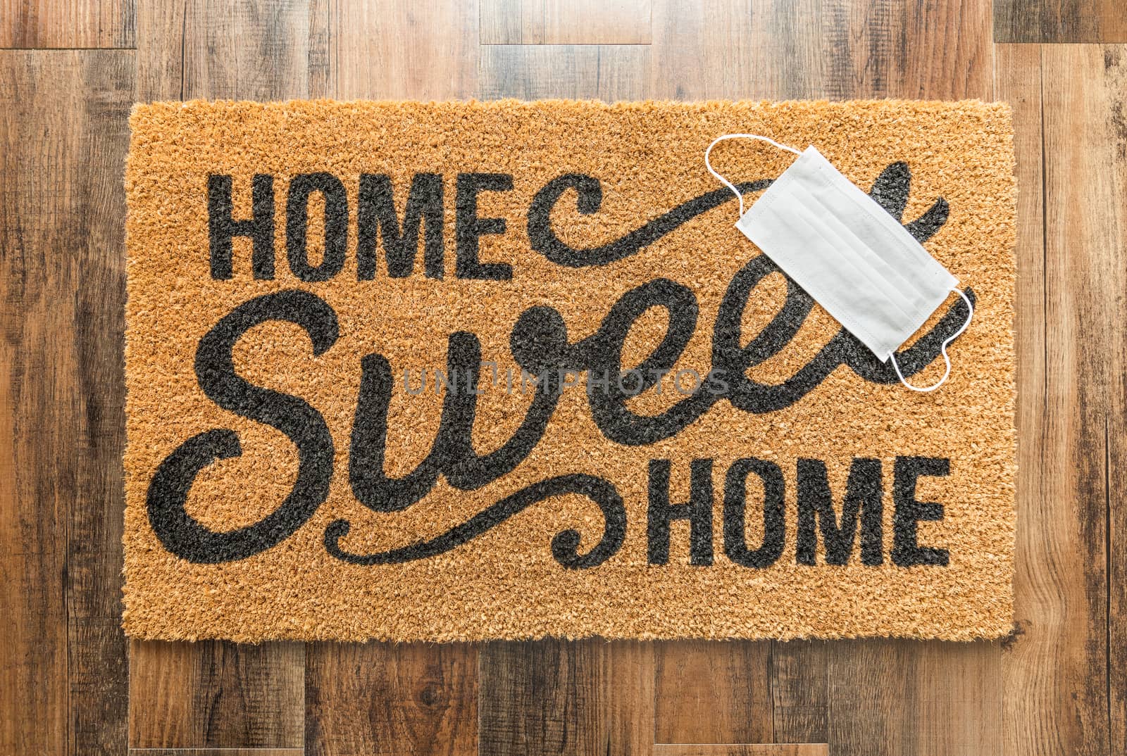 One Medical Face Mask Rests on Home Sweet Home Welcome Mat Amids by Feverpitched