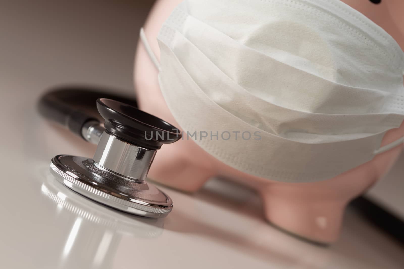 Stethoscope and Piggy Bank Wearing Protective Medical Face Mask.