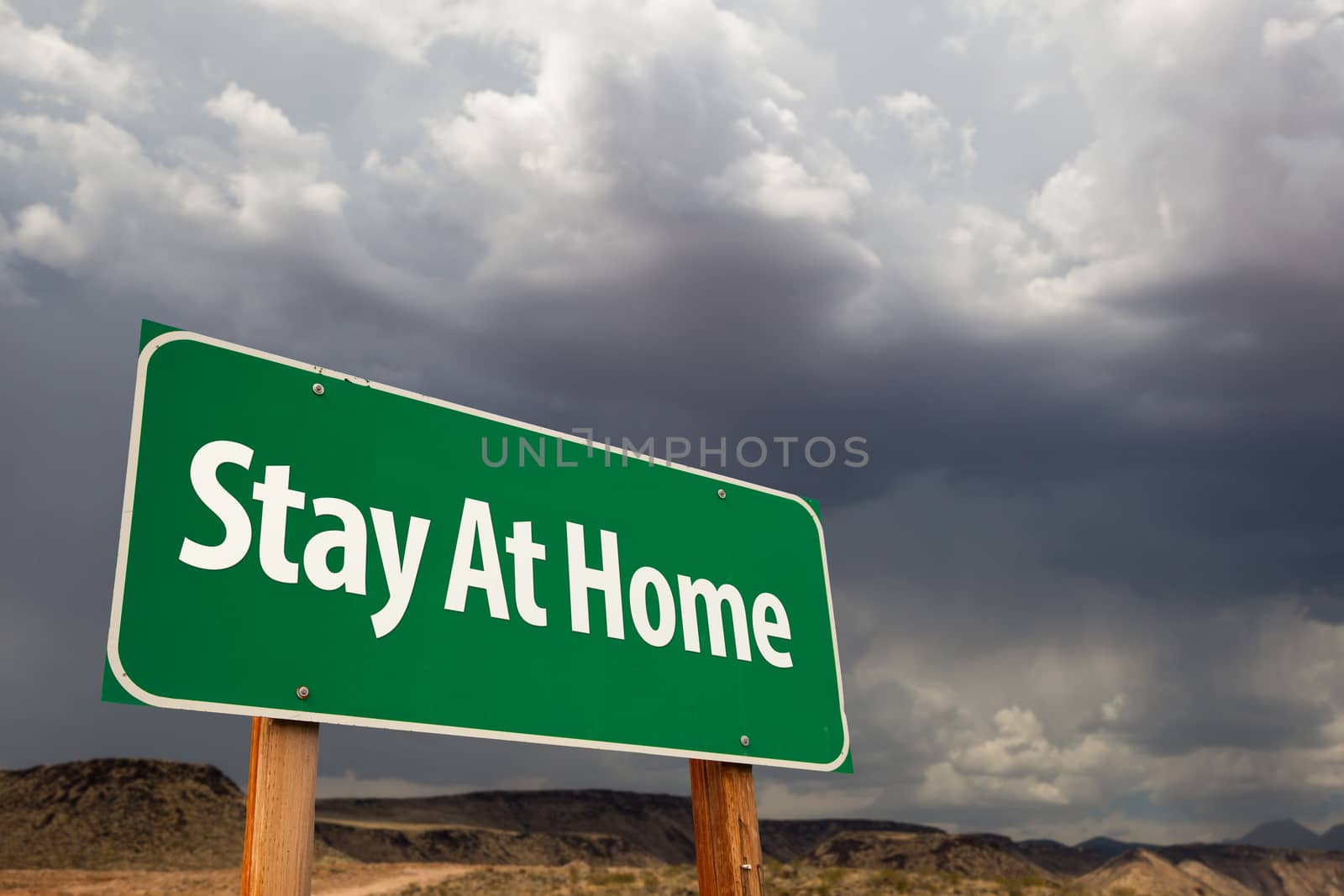 Stay At Home Green Road Sign Against An Ominous Cloudy Sky by Feverpitched