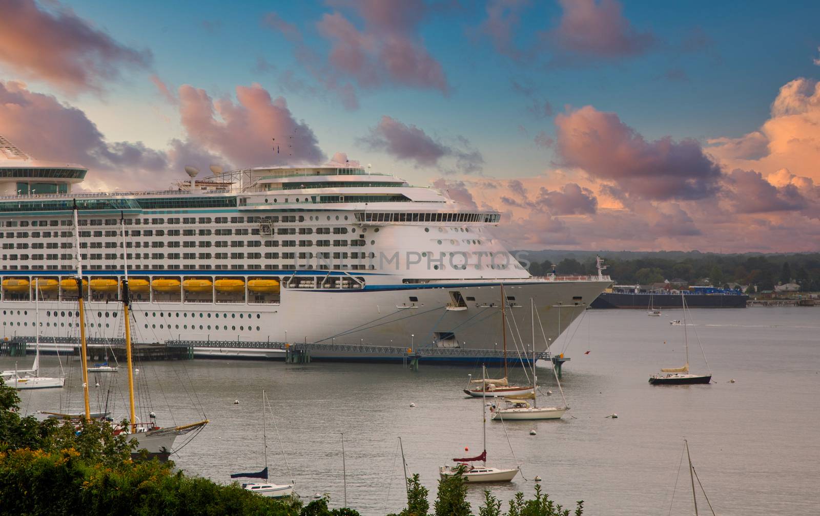 Front of Luxury Cruise Ship with Yellow Lifeboats at Dusk by dbvirago