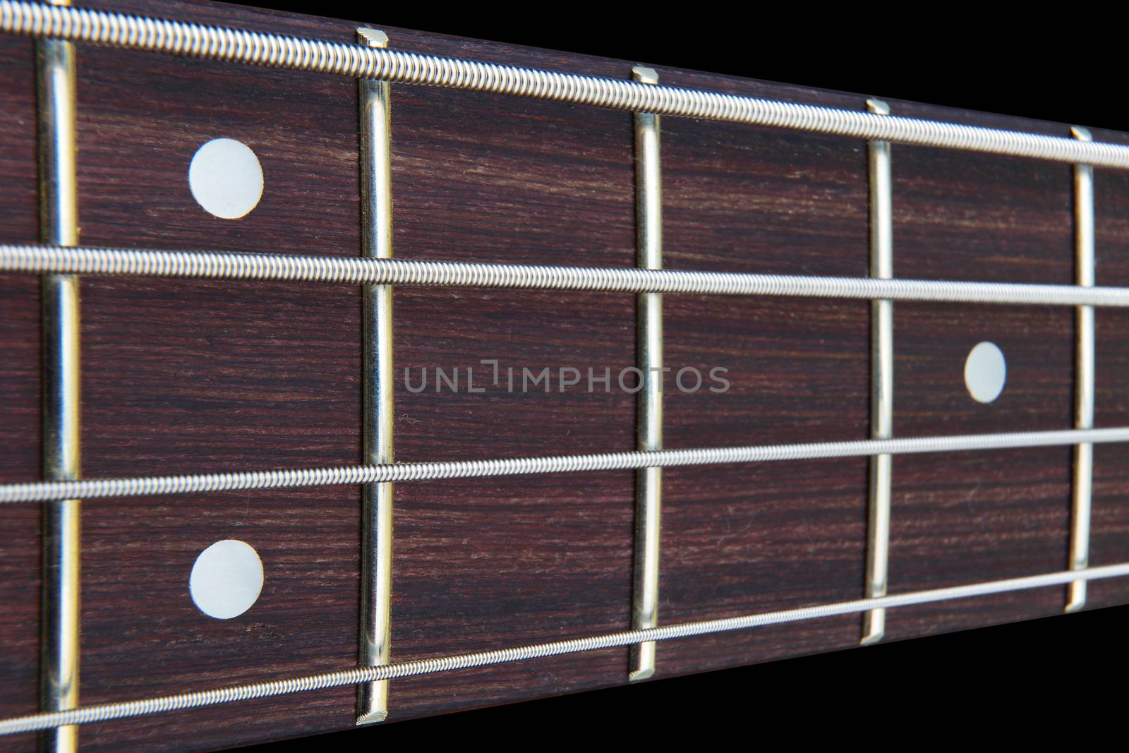 Four string bass guitar fretboard neck with selective focus by VivacityImages