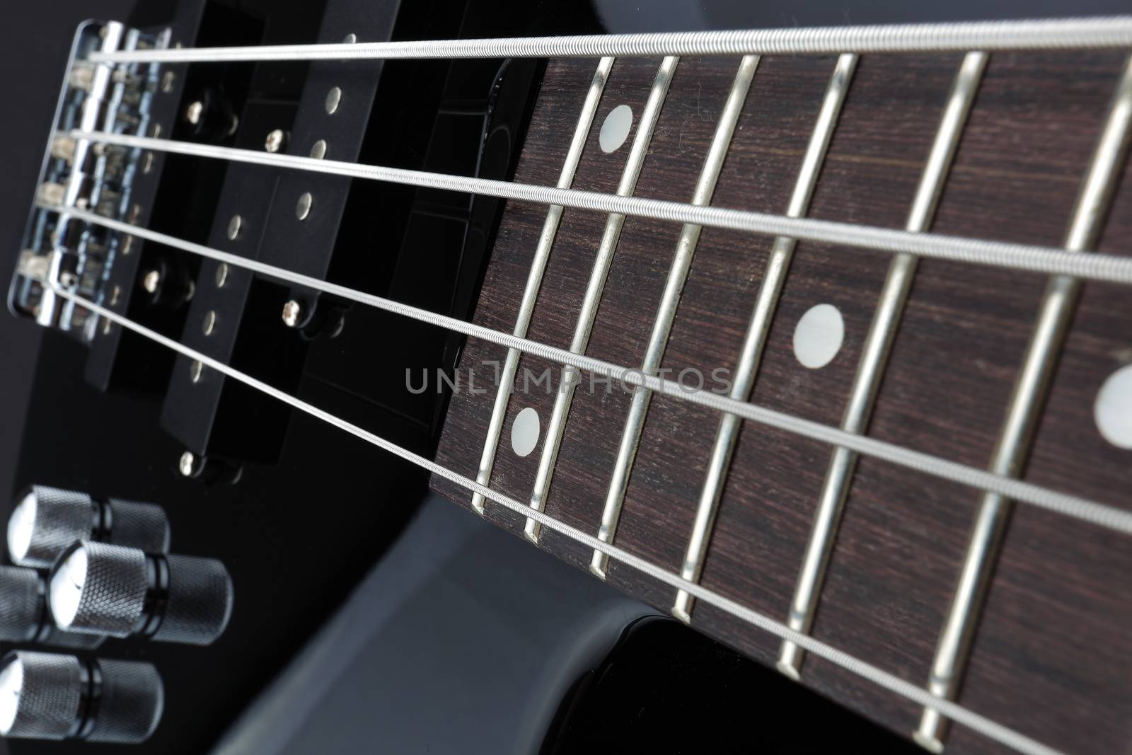 Bass guitar neck pickups bridge volume pots selective focus by VivacityImages